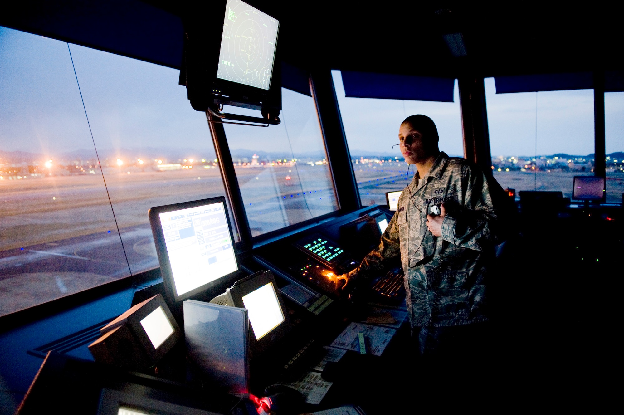 Senior Airman Nissean Johnson watches the flightline and sky for incoming and outgoing aircraft March 24, 2011, at Yokota Air Base, Japan. Yokota AB's flightline has received more than triple the normal amount of aircraft due to Operation Tomodachi. The military and civilian aircraft have been from multiple nations carrying supplies, personnel and equipment in direct support of bringing relief efforts and trying to minimize human suffering following an earthquake and tsunami March 11. Airman Johnson is an air traffic controller assigned to the 374th Operations Support Squadron.(U.S. Air Force photo/Staff Sgt. Jonathan Steffen)
