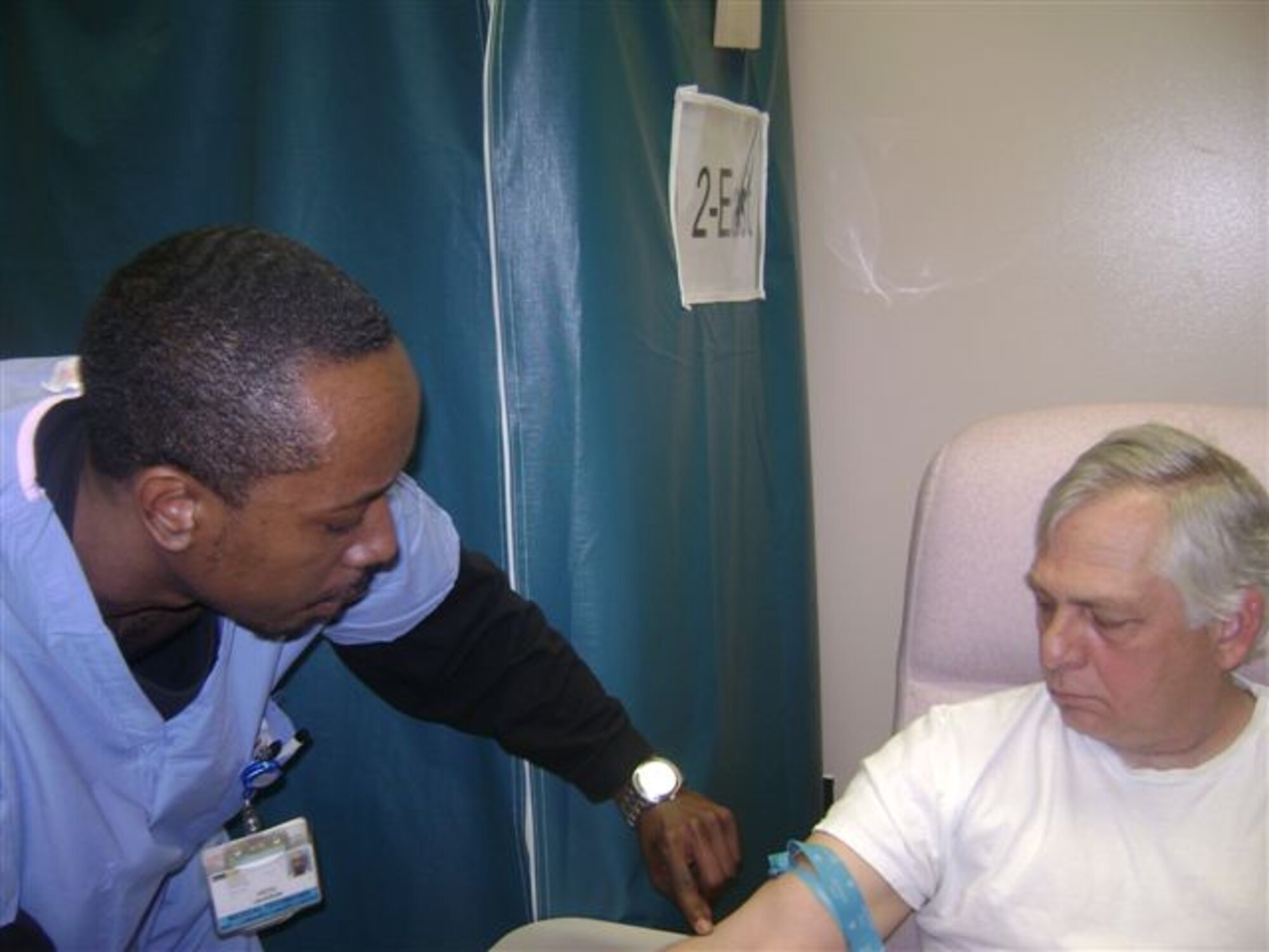Richard Jones watches as Keith Jackson tries to find a vein in his arm. Mr. Jones recently donated stem cells and may have saved a life in the process. (Courtesy photo)

