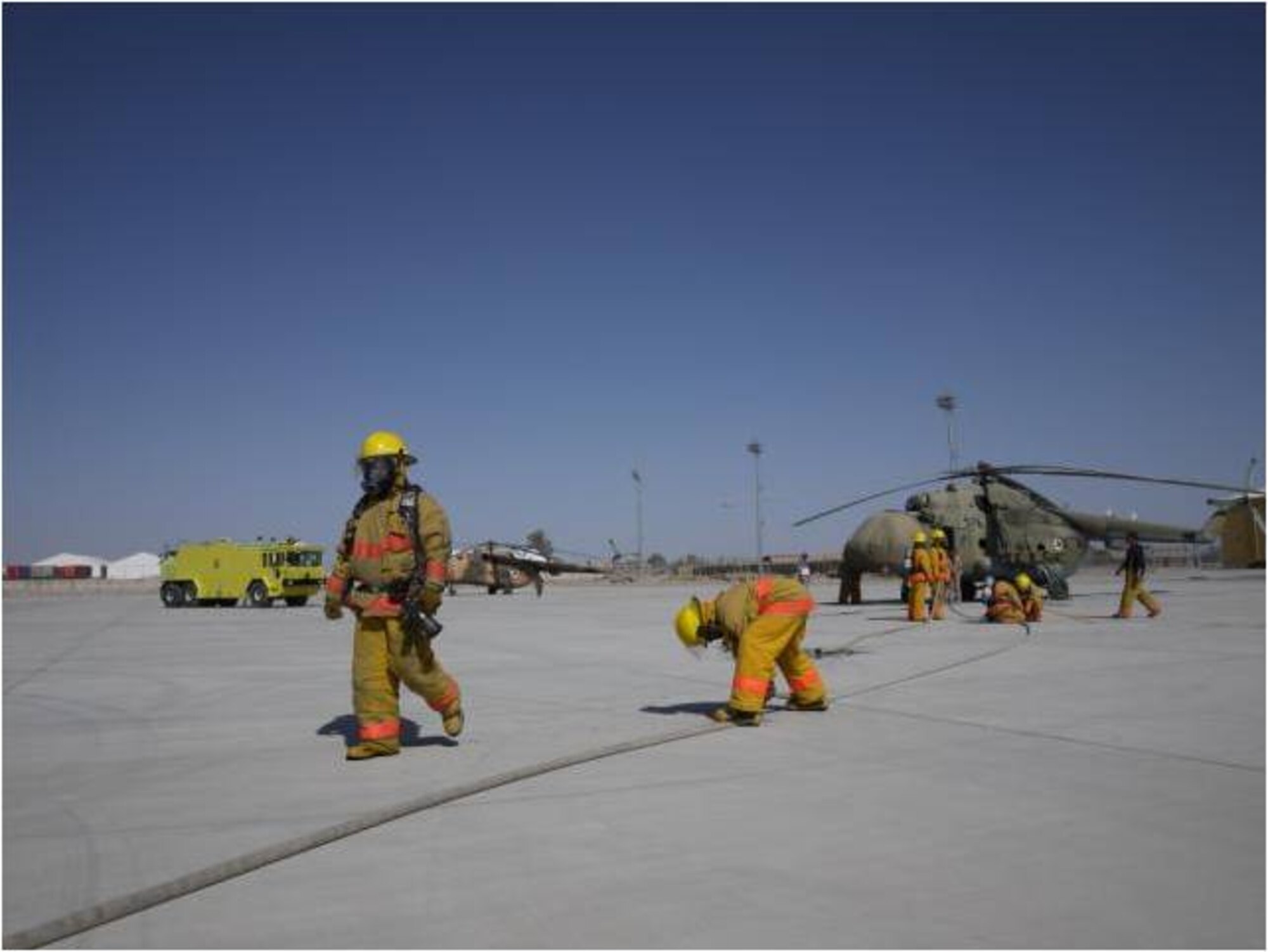 KHANDAR, Afghanistan - On March 24, members of Kandahar Air Wing Firefighters ensure their gear is ready for a real-time fire exercise evaluating the fire department’s proficiency in responding to a Mi-17 aircraft crash at Kandahar Airfield. (U.S. Air Force photo)