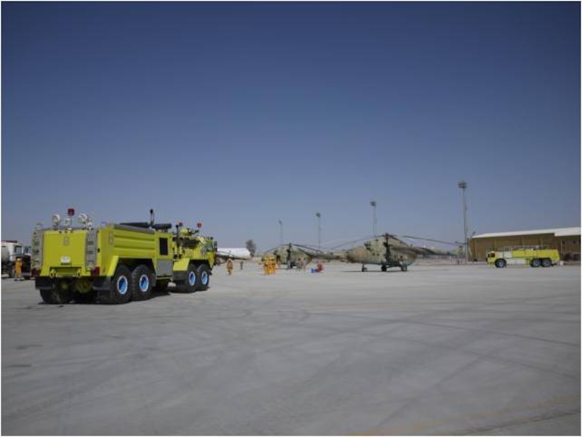 KHANDAR, Afghanistan - On March 24, NATO Fire officials and members of Kandahar Air Wing set-up of three crash vehicles which were part of a real-time fire exercise evaluating the fire department’s proficiency in responding to a Mi-17 aircraft crash at Kandahar Airfield. (U.S. Air Force photo)