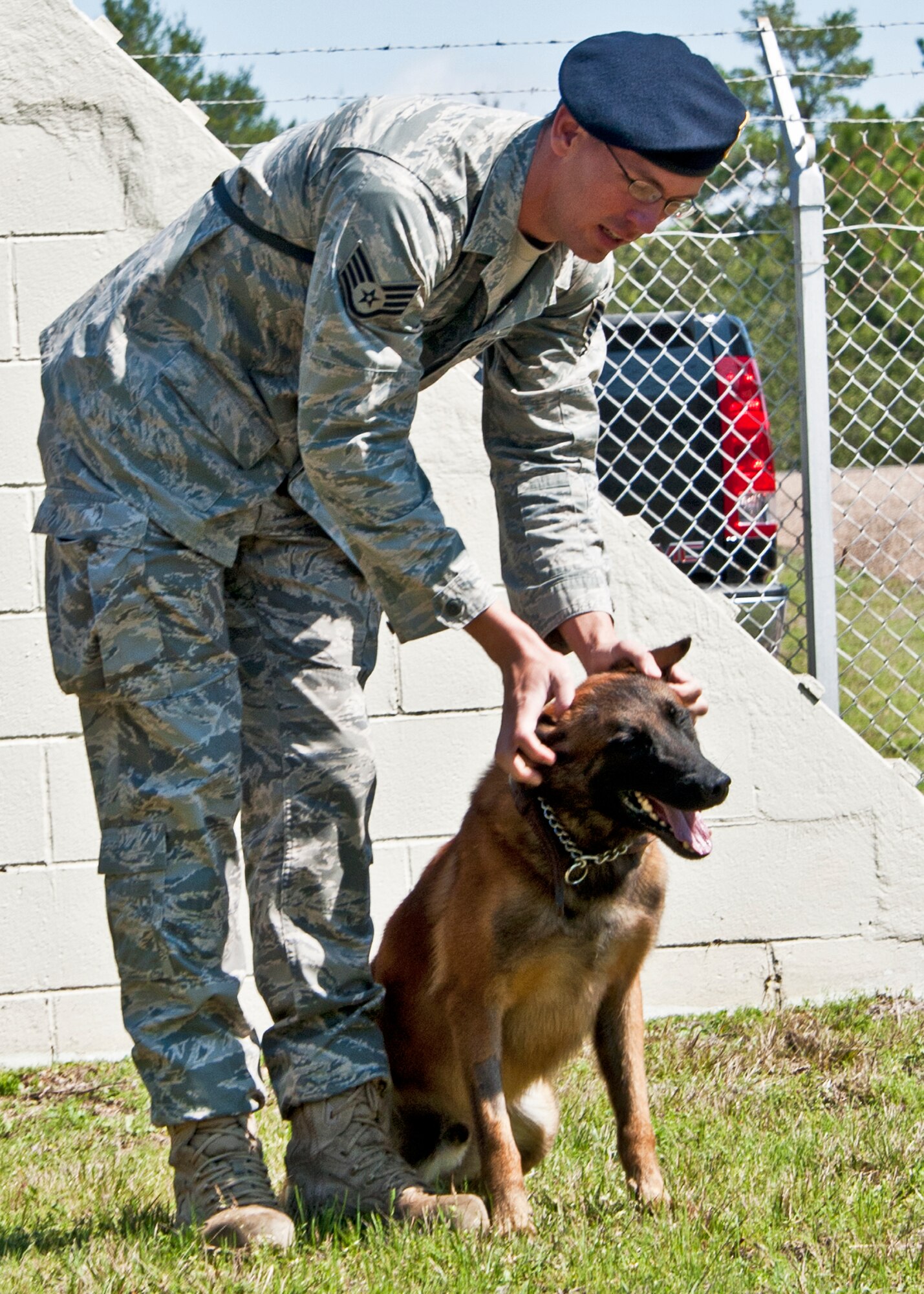 Staff Sgt. David Aenchbacher, 96th Security Forces Squadron military working dog handler, scratches Rex’s ears after a good job on the Eglin kennel obstacle course.  Sergeant Aenchbacher and Rex are just one of the K-9 teams at Eglin.  Eglin’s military working dog teams are expected to maintain training, perform vehicle searches, patrols, building sweeps, dorm checks and demonstrations.   They also help local law enforcement with further K-9 training both at Eglin and outside the gate.   (U.S. Air Force photo/Samuel King Jr.)