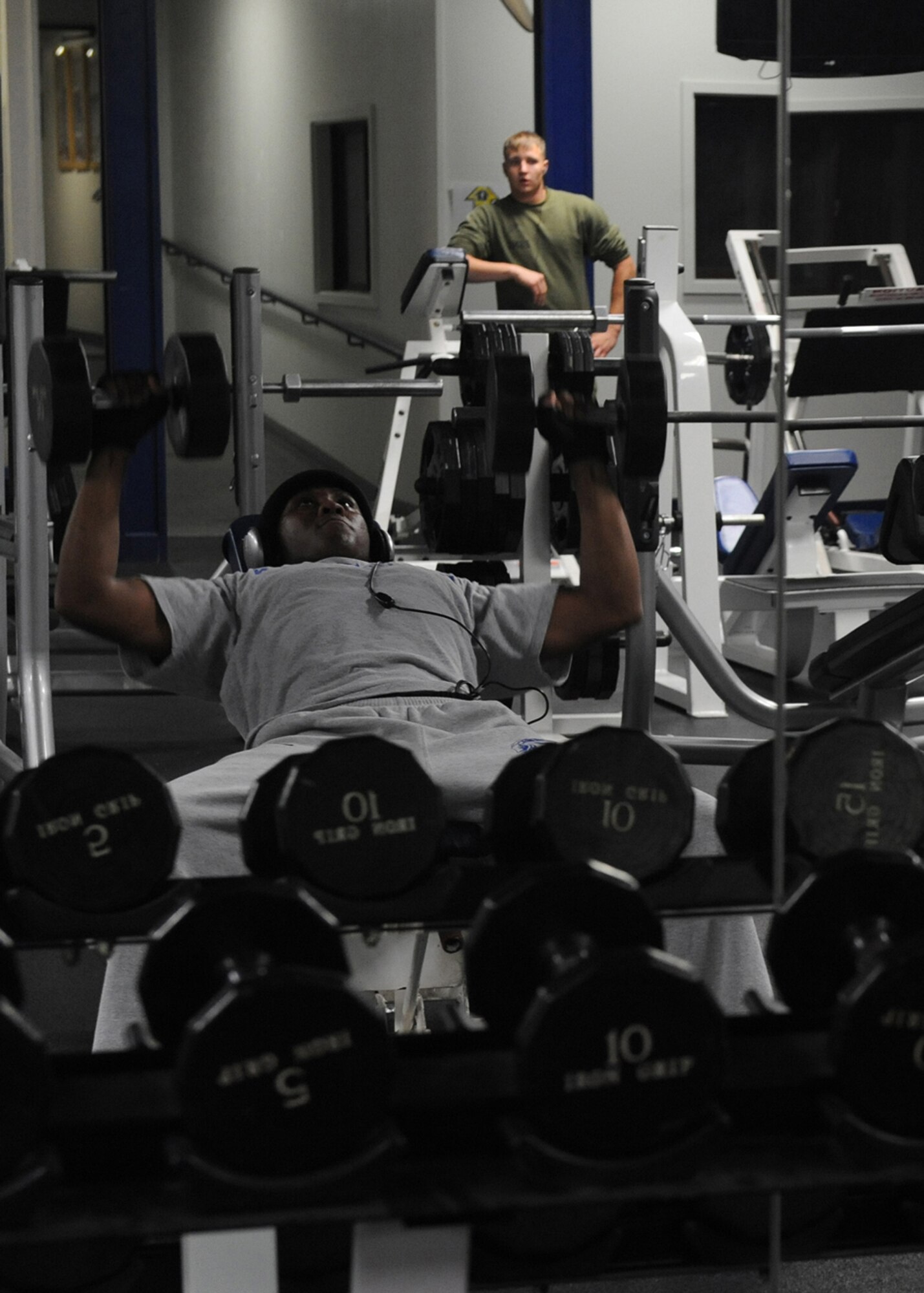 MISAWA AIR BASE, Japan -- Airman 1st Class Jarrod Alford, 35th Security Forces Squadron, lifts weights at the Potter Fitness Center on March 25. The fitness center has returned to normal operations after being configured for earthquake contingency operations.  It is open Monday-Friday 4 a.m.-10 p.m., Saturday and Sunday 8 a.m.-8 p.m. It is still available for limited contingency lodging with 192 cots set up. Physical training reservations have not resumed yet. (U.S. Air Force photo by Senior Airman Chelsea Cummings)