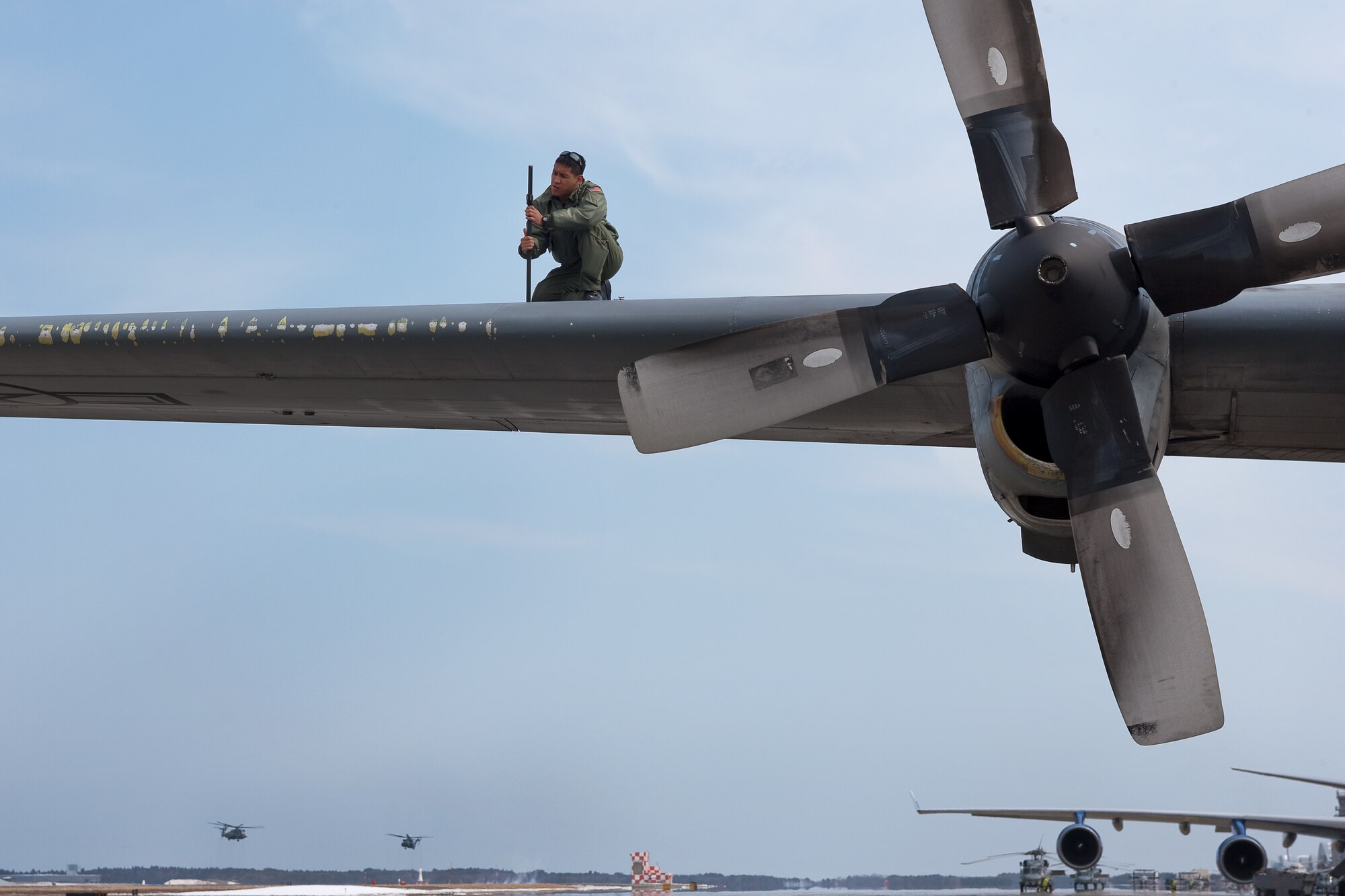 MISAWA AIR BASE, Japan -- Staff Sgt. Nick Cacho, 36th Airlift Squadron, inspects a C-130 Hercules aircraft at Misawa Air Base, March 25 after delivering mission sustaining supplies. A native of Hilo, Hawaii, Sergeant Cacho is a C-130 aircraft flight engineer at Yokota Air Base, Japan and helps support Operation Tomodachi. (U.S. Air Force photo/Osakabe Yasuo)