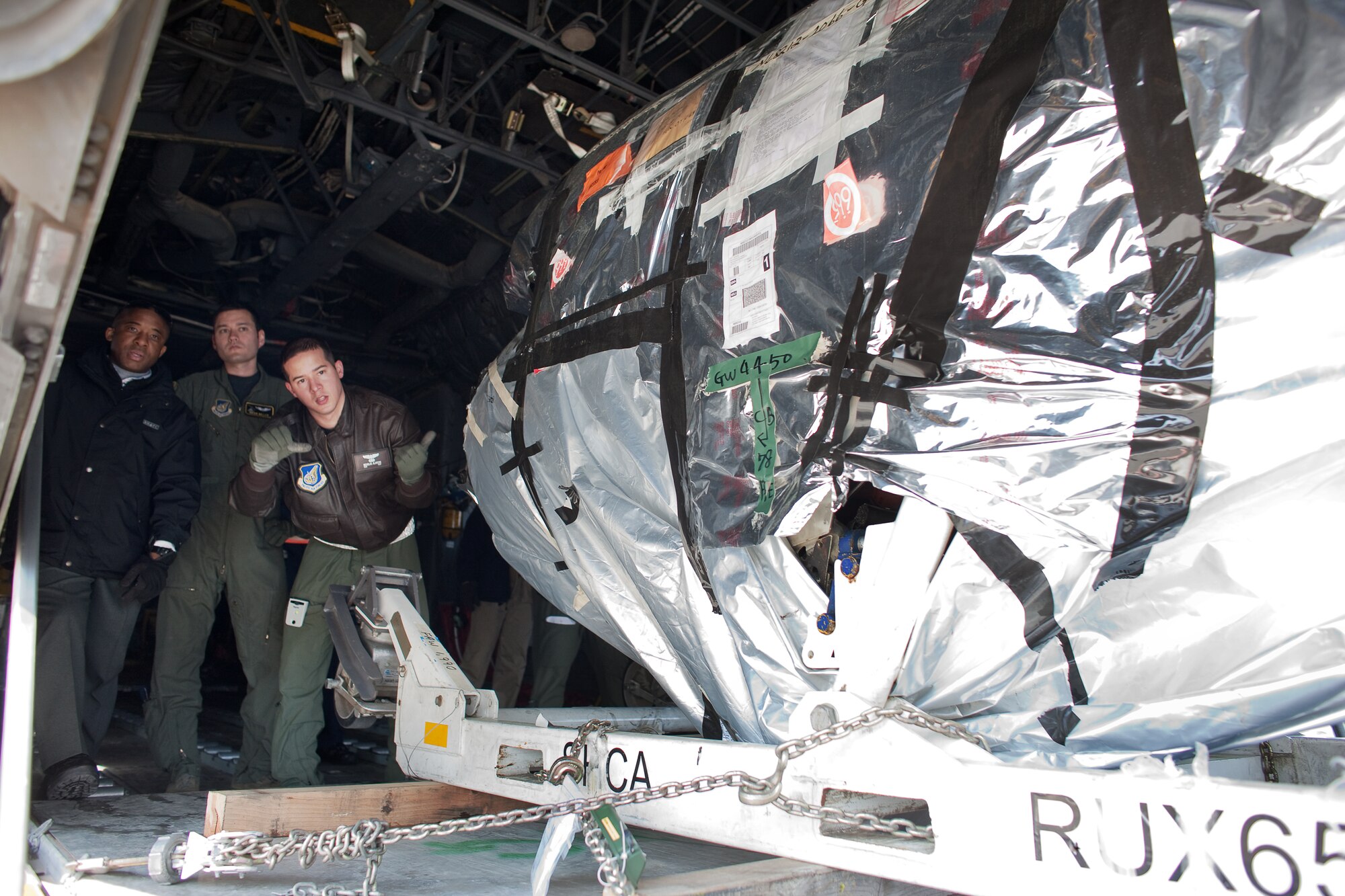 MISAWA AIR BASE, Japan -- Staff Sgt. Nickolas Alarcon (center), marshals an offloading pallet from a C-130 Hercules aircraft at Misawa Air Base, Mach 25 after delivering mission sustaining supplies. A native of Exter, New Hampshire, Sertgeant Alarcon is a C-130 aircraft loadmaster at Yokota Air Base, Japan and helps support Operation Tomodachi. (U.S. Air Force photo/Osakabe Yasuo)