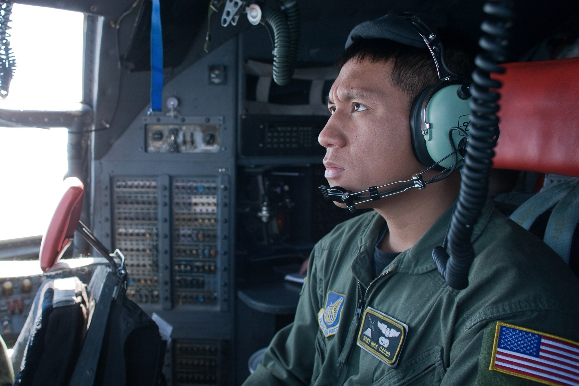 OVER AOMORI PERFECTURE, Japan -- Staff Sgt. Nick Cacho, 36th Airlift Squadron, checks flight engineer instruments during a flight from Yokota Air Base to Misawa Air Base to deliver four pallets of mission essential equipment, March 25. A native of Hilo, Hawaii, Sergeant Cacho is a C-130 aircraft flight engineer at Yokota Air Base, Japan and helps support Operation Tomodachi. (U.S. Air Force photo/Osakabe Yasuo)