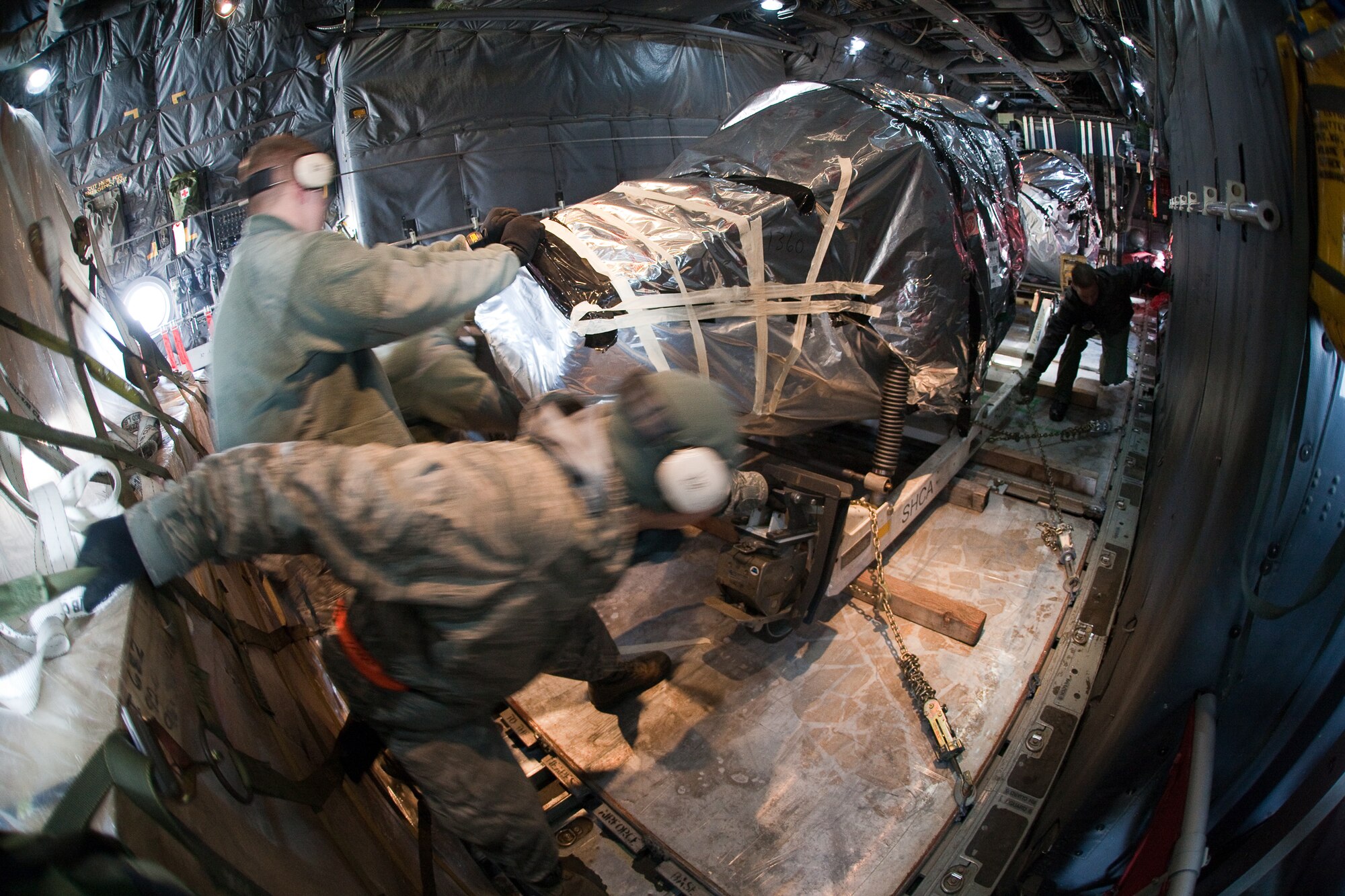 YOKOTA AIR BASE, Japan -- Members from the 374th Logistics Readiness Squadron and 374th Aircraft Maintenance Squadron work together to load heavy cargo at Yokota Air Base, March 25. This payload will help sustain relief operations taking place at Misawa Air Base. Since the March 11 earthquake and tsunami, Yokota's C-130s play a critical role in ongoing relief efforts rapidly providing supplies where they are needed most. (U.S. Air Force photo/Osakabe Yasuo)