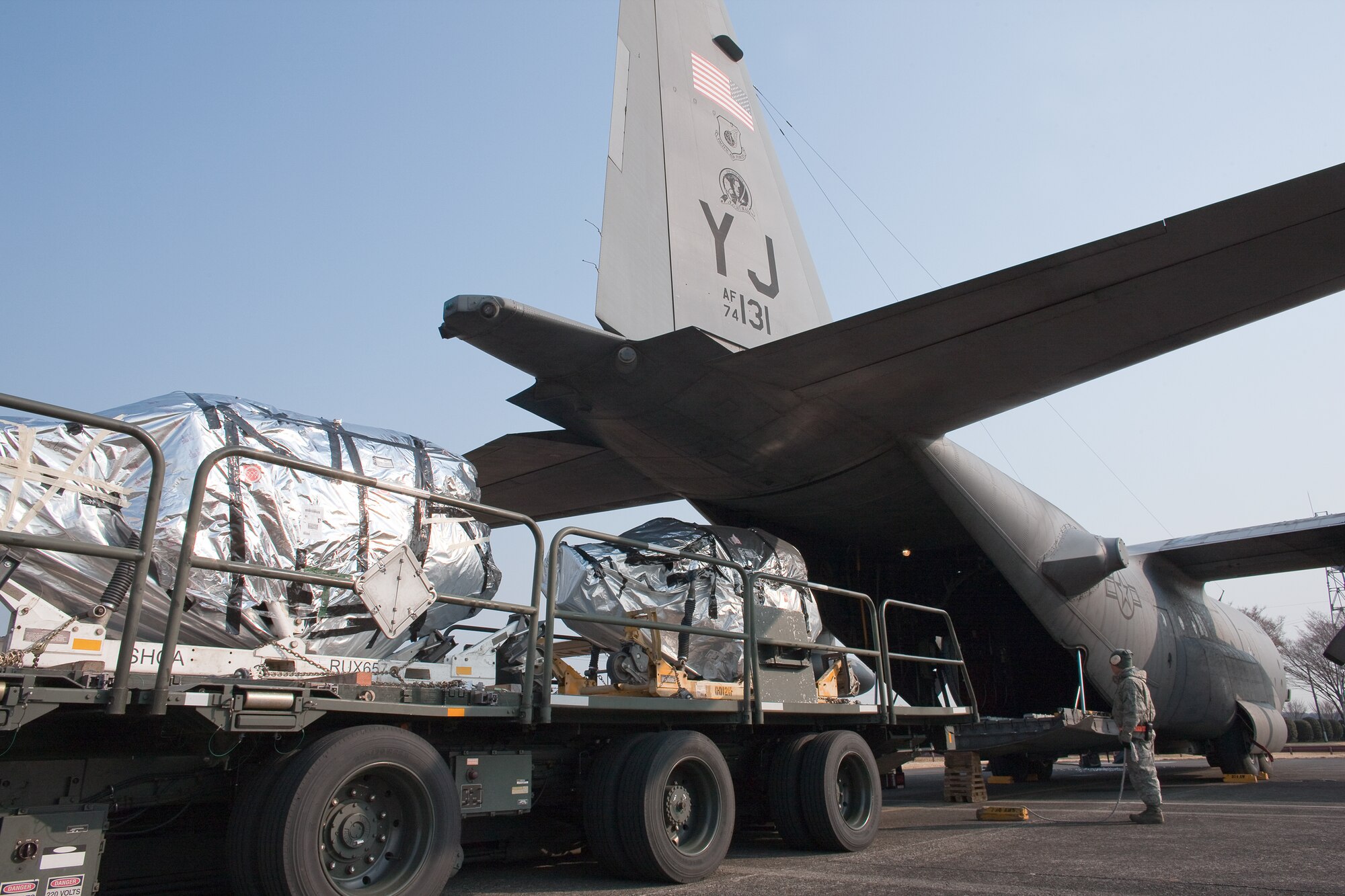 YOKOTA AIR BASE, Japan -- Members from the 374th Logistics Readiness Squadron load cargo onto a C-130 Hercules aircraft bound at Yokota Air Base, March 25. This payload will help sustain relief operations taking place at Misawa Air Base. Since the March 11 earthquake and tsunami, Yokota aircrews have worked around the clock delivering vital supplies in support of Operation Tomodachi. (U.S. Air Force photo/Osakabe Yasuo)