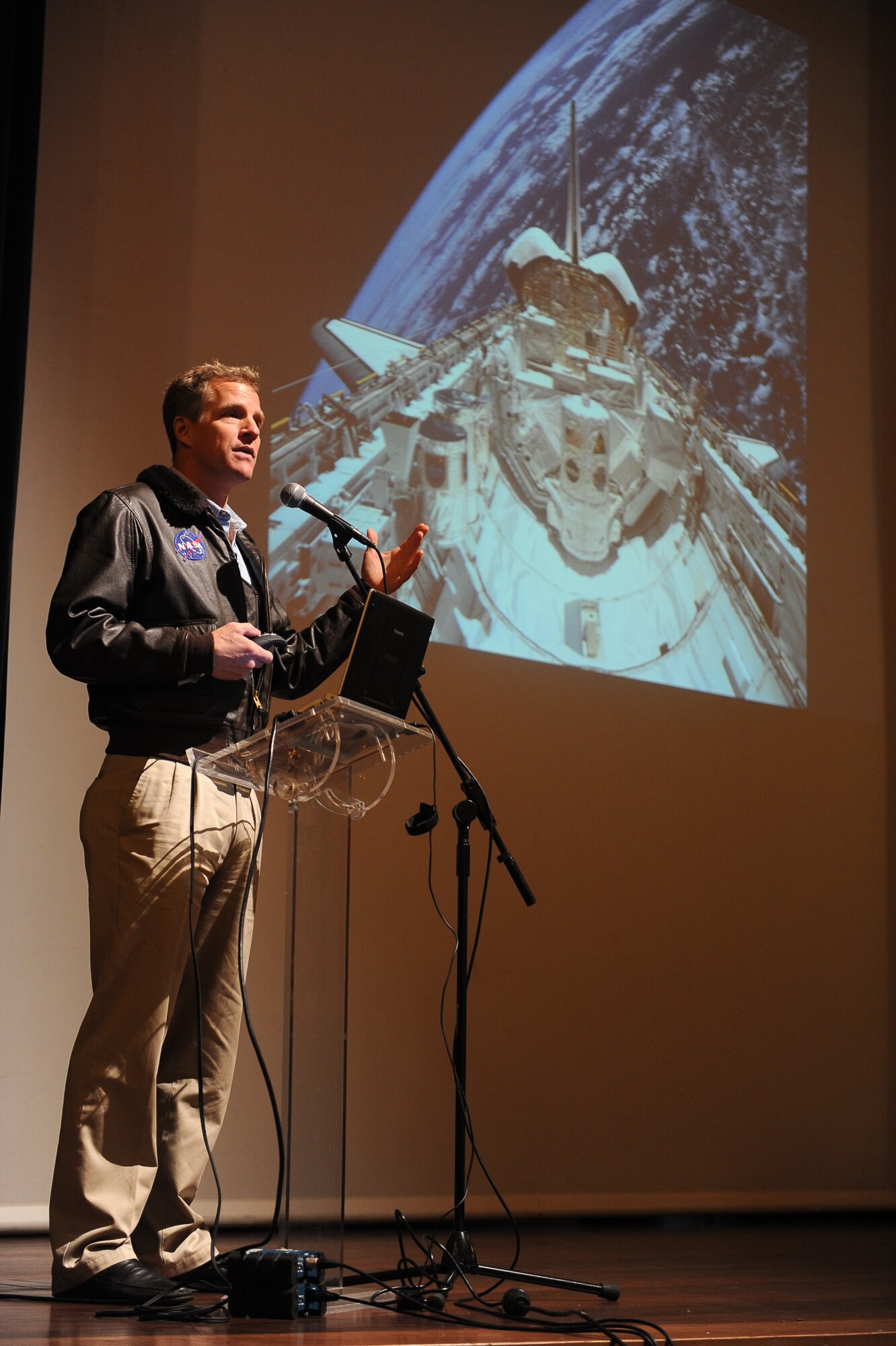 Dr. Scott E. Parazynski, a former National Aeronautics and Space Administration lead astronaut, addresses a local community audience about one of his voyages during a visit to Auditorio do Ramo Grande, Praia da Vitoria, March 17, 2011. Dr. Parazynski also visited and talked with students in a Portuguese school during his visit to Lajes Field.  (Photo by Guido Melo)