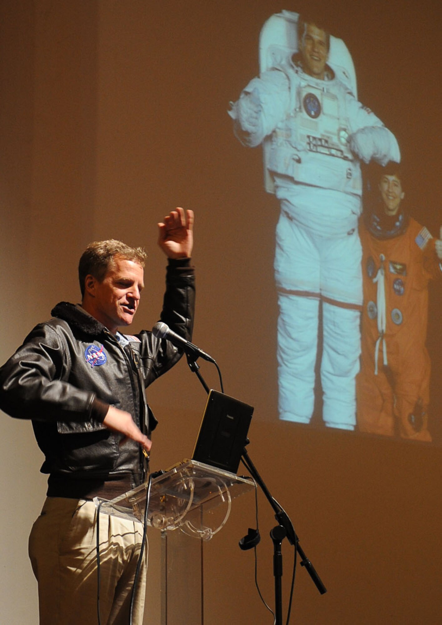 Dr. Scott E. Parazynski, a former National Aeronautics and Space Administration lead astronaut, addresses a local community audience about one of his voyages during a visit to Auditorio do Ramo Grande, Praia da Vitoria, March 17, 2011. Dr. Parazynski also visited and talked with students in a Portuguese school during his visit to Lajes Field.  (Photo by Guido Melo)