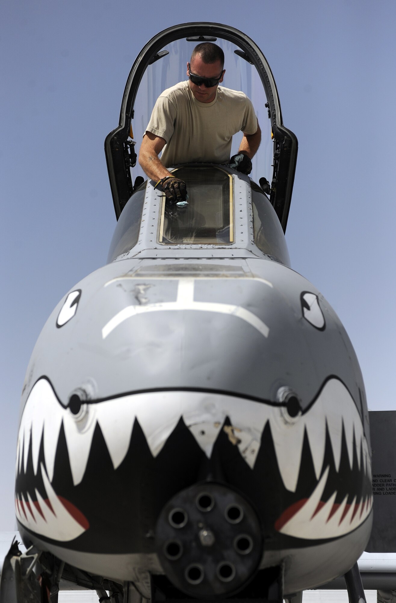 Airman 1st Class Brian Littrell puts the final touches on an A-10C Thunderbolt post-flight March 24, 2011, at Kandahar Air Field, Afghanistan. Airman Littrell is an A-10 dedicated assistant crew chief stationed at Moody Air Force Base, Ga., but currently assigned to the 74th Expeditionary Fighter Squadron. (U.S. Air Force photo/Senior Airman Willard E. Grande II)