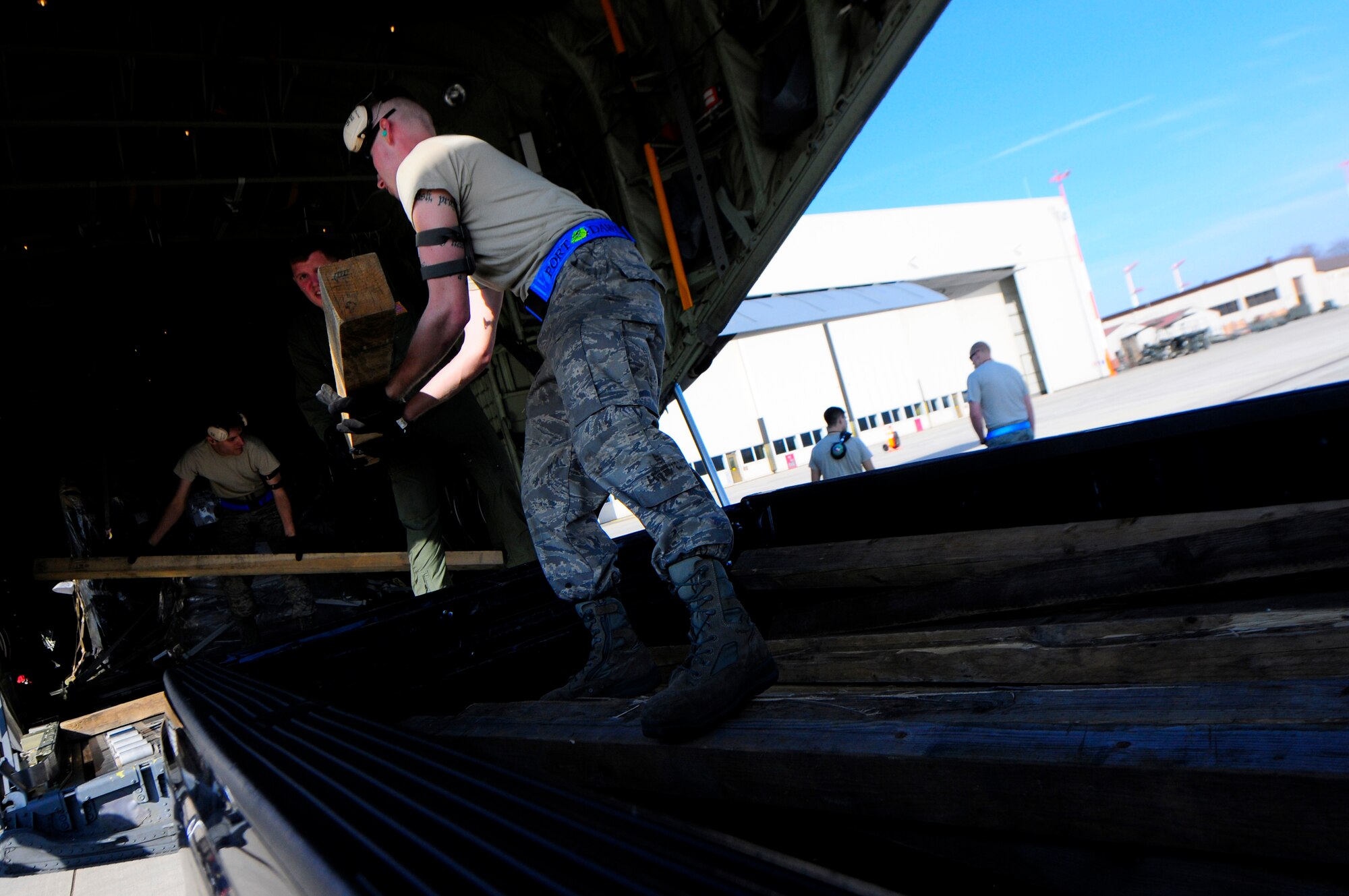 U.S. Air Force Airmen from the 721st Aerial Port Squadron load cargo onto a C-130J Super Hercules for its departure in support of Joint Task Force Odyssey Dawn, Ramstein Air Base, Germany, March 24, 2011. Joint Task Force Odyssey Dawn is the U.S. Africa Command task force established to provide operational and tactical command and control of U.S. military forces supporting the international response to the unrest in Libya and enforcement of United Nations Security Council Resolution 1973. UNSCR 1973 authorizes all necessary measures to protect civilians in Libya under threat of attack by Qadhafi regime forces. JTF Odyssey Dawn is commanded by U.S. Navy Admiral Samuel J. Locklear, III. (U.S. Air Force Photo by Airman 1st Class Brea Miller)