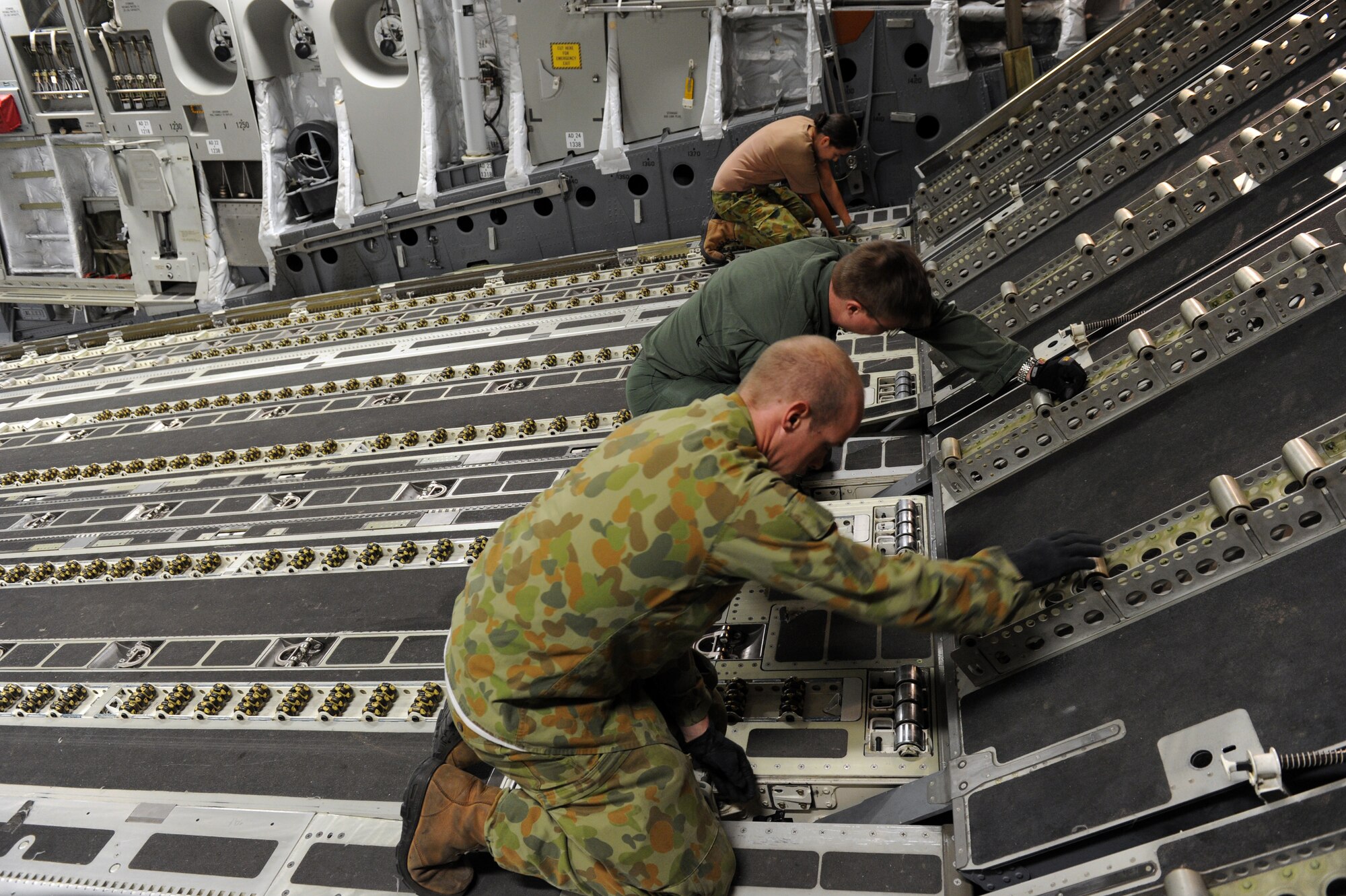YOKOTA AIR BASE, Japan -- Members of the Royal Australian Air Force prepare their C-17 Globemaster III for cargo prior to take off March 24. Yokota Airmen have had the rare opportunity to work the 36th Squadron and 1st Aircraft Operation Support Squadron from the RAAF during Operation Tomodachi. (U.S. Air Force photo/Senior Airman Michael J. Veloz)