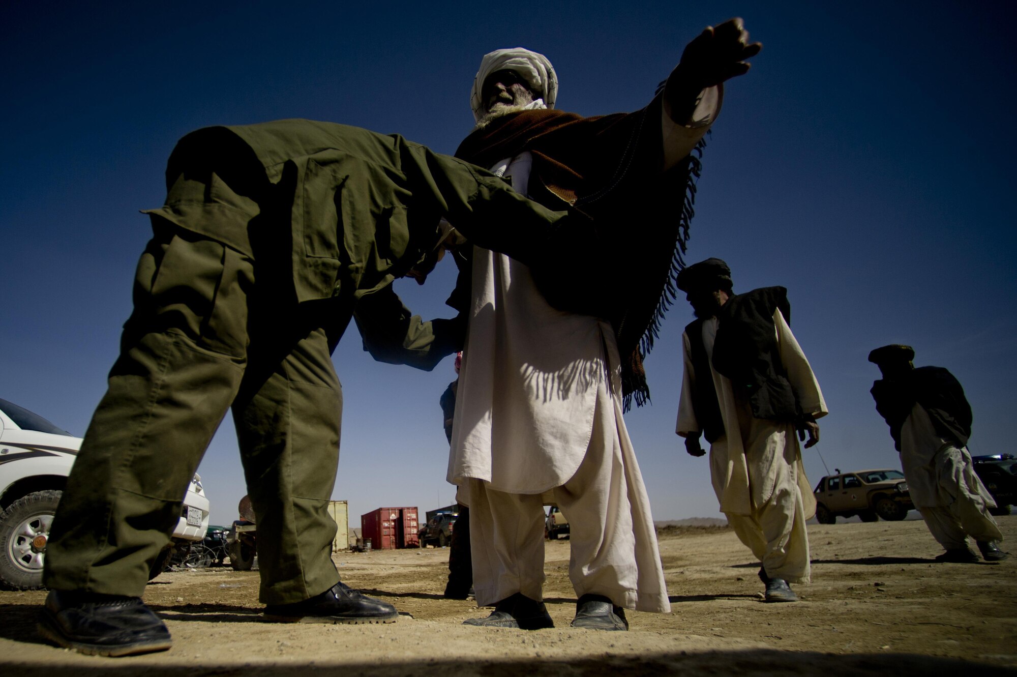 An Afghan national army soldier searches Shamulzai District residents for any contraband at the local police headquarters in the Shamulzai District of the Zabul province in Afghanistan. Shamulzai District residents were attending a diplomacy shura to voice their needs and concerns to the Zabul province governor who was in attendance. (U.S. Air Force photo/Master Sgt. Adrian Cadiz)