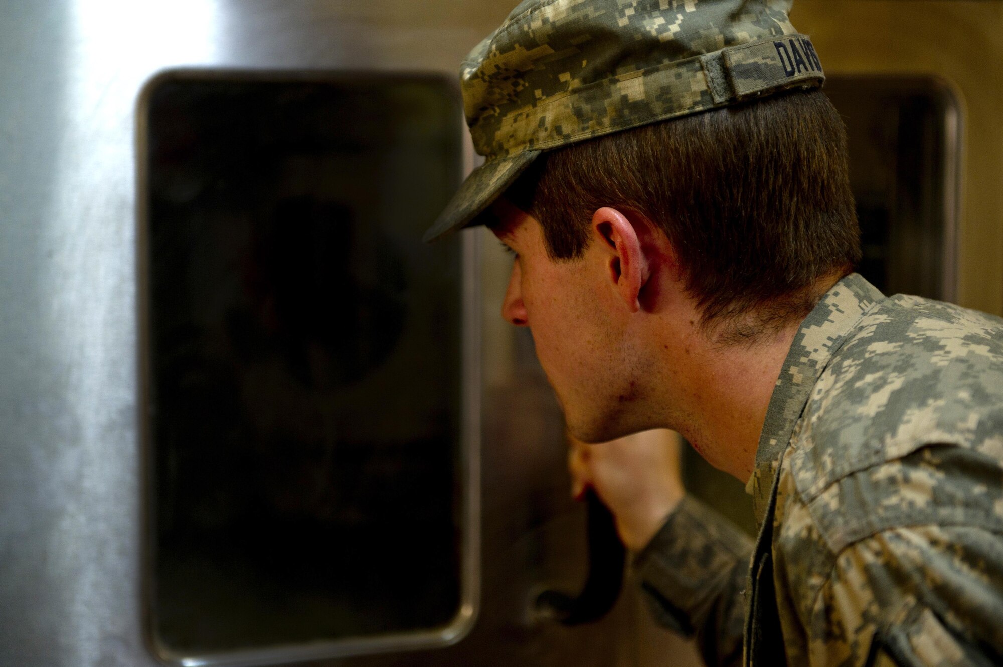 Senior Airman Bryant Davis, Provincial Reconstruction Team Zabul cook, checks a stove as he cooks dinner at Forward Operating Base Smart, Afghanistan. Airman Davis is assigned to the dining facility kitchen staff and is responsible for preparing meals for PRT Zabul. PRT Zabul consists of members from the Air Force, Army and other civilian agencies. Sergeant Davis is deployed from the 375th Force Support Squadron, Scott AFB, Ill. (U.S. Air Force photo/Master Sgt. Adrian Cadiz)