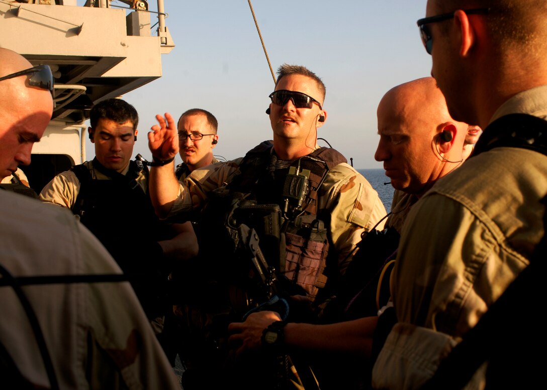 Navy Chief Petty Officer Nathan P. Rose, an assistant boarding officer, briefs the guided-missile cruiser USS Leyte Gulf’s visit, board, search and seizure team before boarding the Philippine-flagged merchant vessel Falcon Trader II, which had sent out a distress call reporting it had been boarded by pirates in the Arabian Sea, March 25, 2011. U.S. Navy photo by Petty Officer 3rd Class Robert Guerra