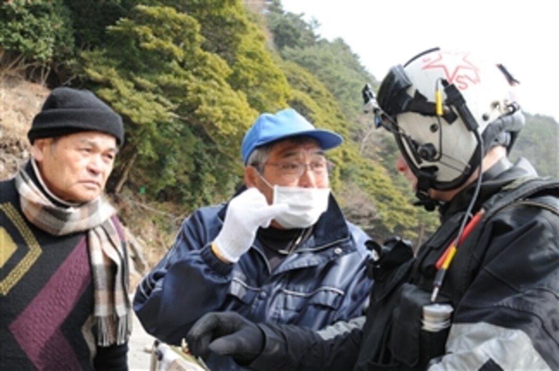 U.S. Navy Petty Officer 2nd Class Justin Dowd (right), with Helicopter Anti-Submarine Squadron 4, speaks with Japanese citizens to identify areas affected by an earthquake and tsunami while supporting humanitarian relief efforts in Ayukawahama, Japan, on March 20, 2011.  The squadron is embarked with Carrier Air Wing 14 on the aircraft carrier USS Ronald Reagan (CVN 76).  The Ronald Reagan is operating off the coast of Japan to provide disaster relief and humanitarian assistance in support of Operation Tomodachi.  