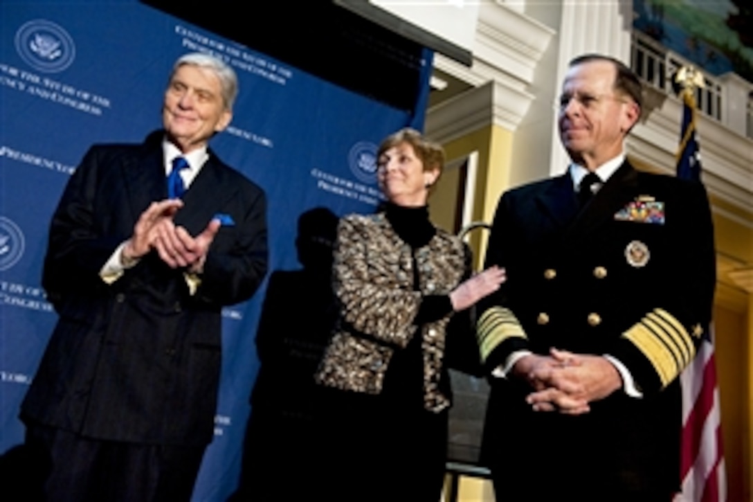 Retired Sen. John W. Warner of Virginia presents Navy Adm. Mike Mullen, chairman of the Joint Chiefs of Staff, and his wife, Deborah, the Dwight D. Eisenhower Award for excellence at the Center for the Study of the Presidency and Congress awards dinner in Washington, D.C., March 24, 2011. Mullen accepted the award on behalf of the U.S. Armed Forces at the dinner.