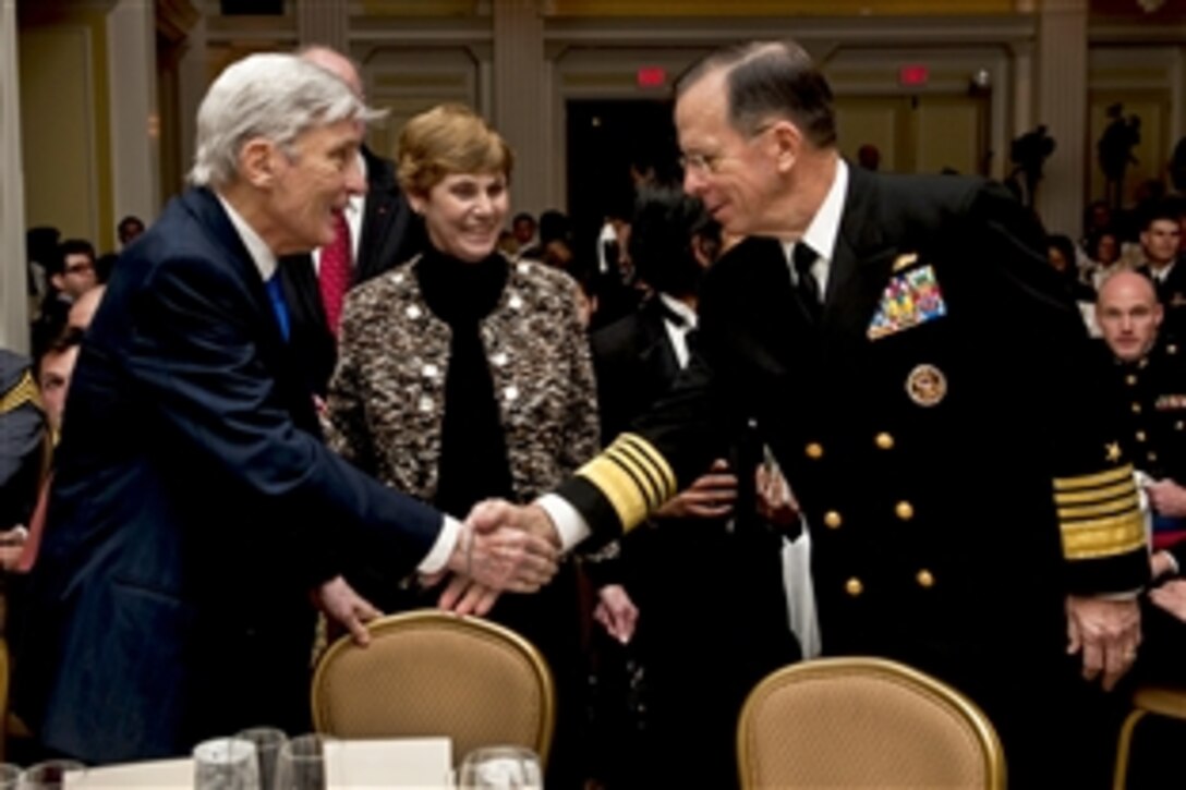 Navy Adm. Mike Mullen, chairman of the Joint Chiefs of Staff, and his wife, Deborah, greet retired Sen. John W. Warner of Virginia at the Center for the Study of the Presidency and Congress awards dinner in Washington, D.C., March 24, 2011. Mullen accepted the Dwight D. Eisenhower Award for excellence on behalf of the U.S. Armed Forces at the dinner.