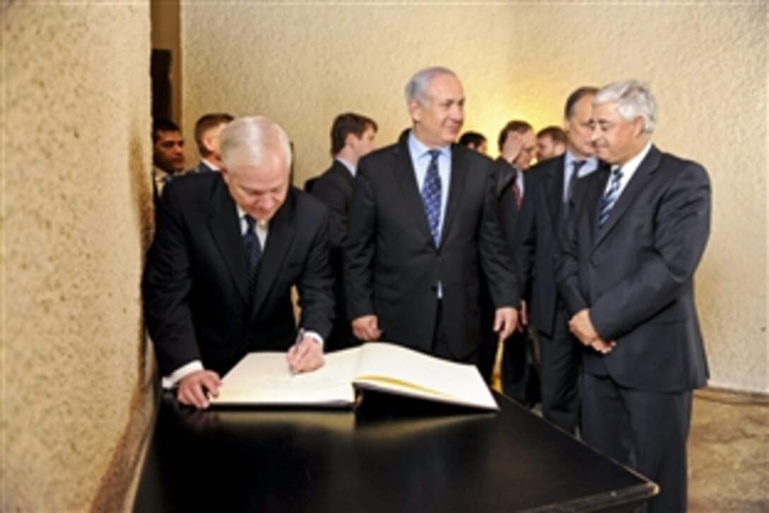 U.S. Defense Secretary Robert M. Gates signs the guest book after meeting with Israeli Prime Minister Benjamin Netanyahu at the Dan Cesarea Hotel in Israel, March 25, 2011.
