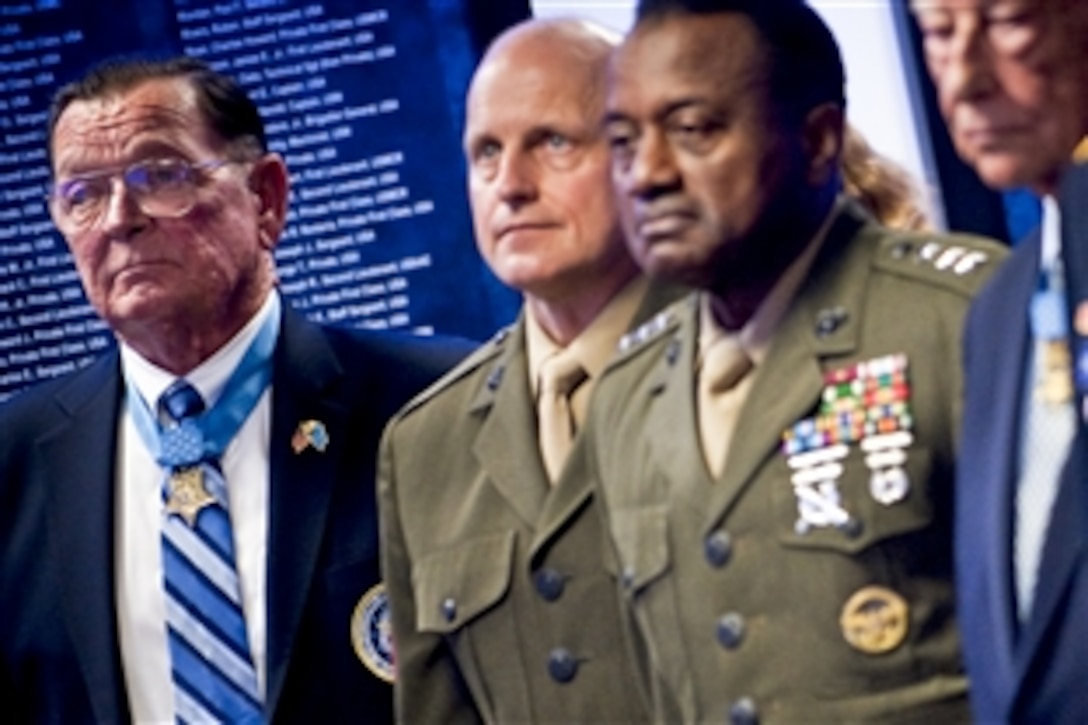 Medal of Honor recipient Richard Pittman, left, stands during the playing of the "Service Medley" at a ceremony honoring the 150th anniversary of the Medal of Honor in the Pentagon's Hall of Heroes, Washington, D.C., March 25, 2011. 