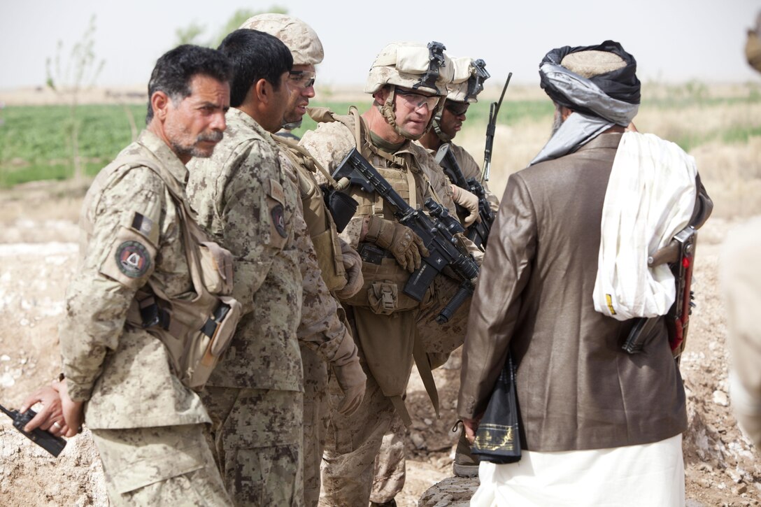Lt. Col. David Hudspeth, the commanding officer of 3rd Battalion, 9th Marine Regiment, speaks to a government official of Marjah District, Helmand province, Afghanistan, before a shura in Southern Marjah that concluded Operation Watchtower, March 25.