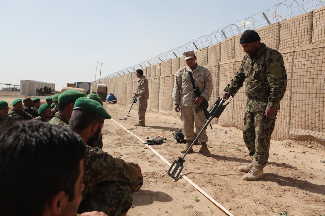 Cpl. Joshua E. Berryhill oversees one Afghan National Army soldiers demonstrating the proper way to mark a possible Improvised Explosive Device threat to his peers. The Broken Arrow, Okla., native is an IED lane advisor with the Embedded Training Team, Regimental Combat Team 1 and teaches two classes a week to the ANA soldiers.