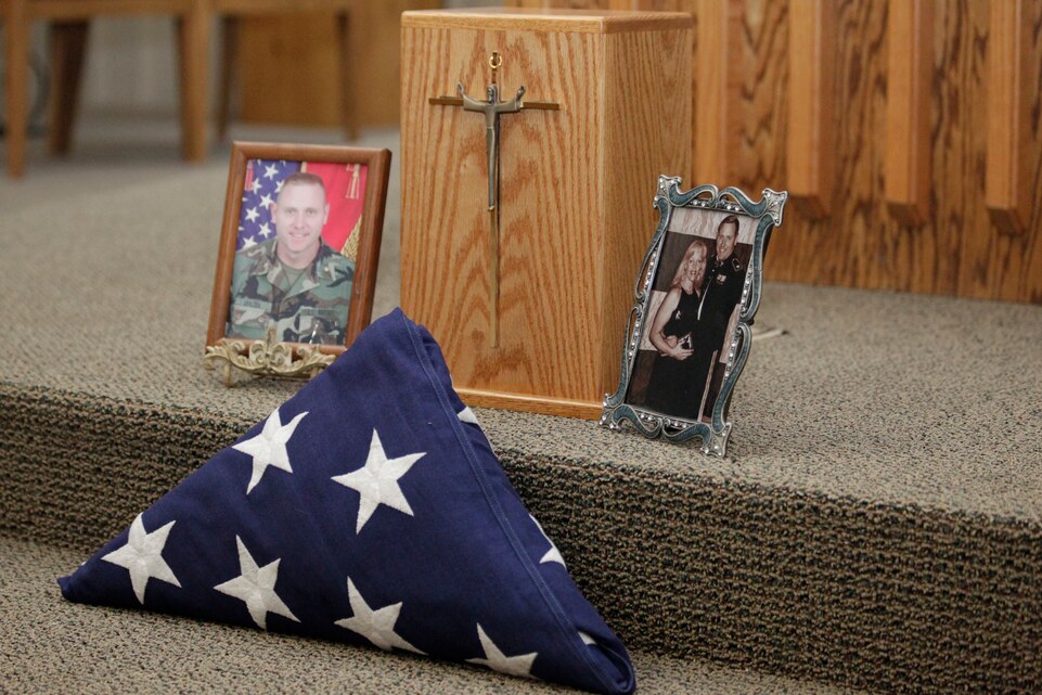 A memorial was placed at the front of the Combat Center’s Catholic Chapel March 26, 2011to honor retired Marine Maj. Mitchell Arnzen during his memorial ceremony.