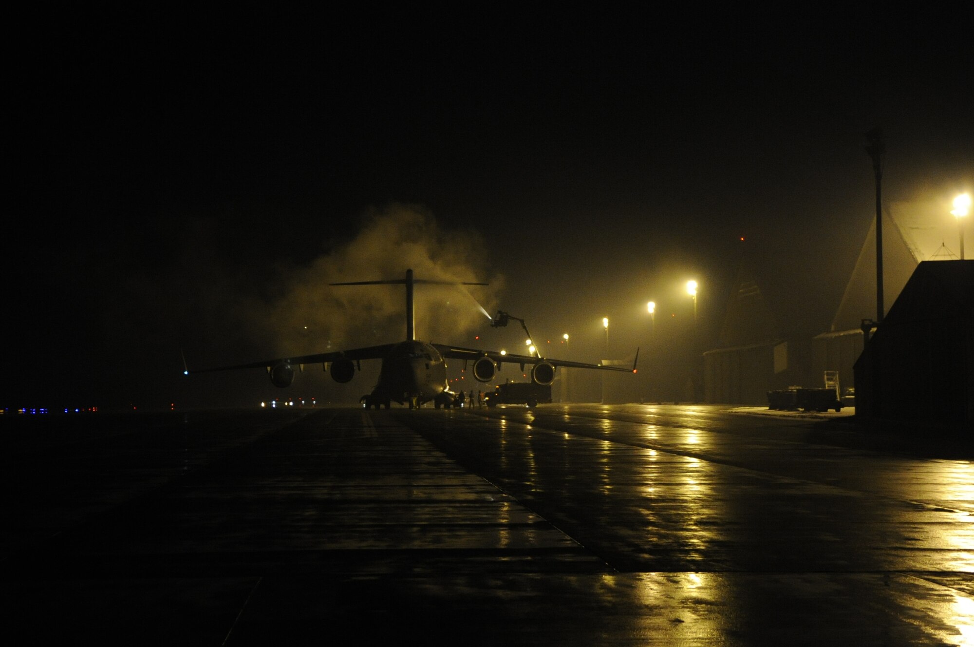 A C-17 Globemaster is de-iced prior to departure by ground crew members at Misawa Air Base, Japan, March 26.  De-icing the aircraft ensures it is safe and properly prepared before departing with cargo or personnel. (U.S. Air Force photo by Staff Sgt. Raymond Mills, Released)
