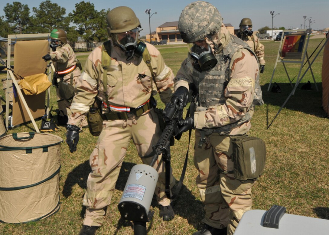 An airman from the 147th Reconnaissance Wing clears his weapon upon entering a decontamination station during Operational Readiness Exercise (ORE) Lonestar 11-01  at Ellington Field Joint Reserve Base, Houston, 6 March 2011.  147 RW Photo/MSgt Dale Hanson

 



