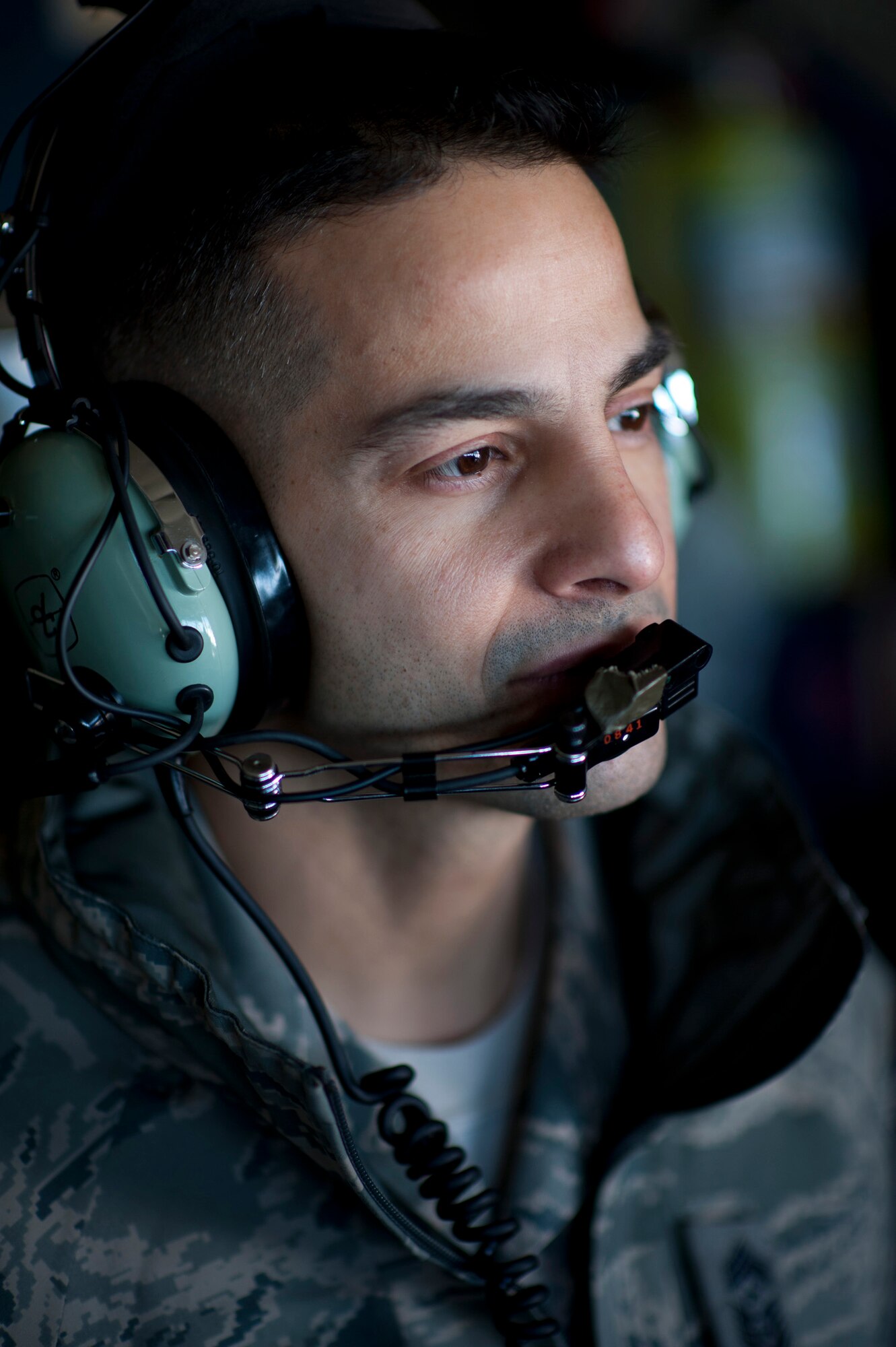 OVER JAPAN -- Chief Master Sgt. Benjamin Caro Jr., 374th Airlift Wing command chief master sergeant, looks out the window of a C-130H Hercules at the destruction still present at Sendai Airport, Japan, March 26, 2011. Chief Caro flew with Col. Otto Feather, 374th AW commander, to fly five pallets of potable water to Sendai Airport for Japanese citizens in need. (U.S. Air Force photo/Staff Sgt. Samuel Morse)