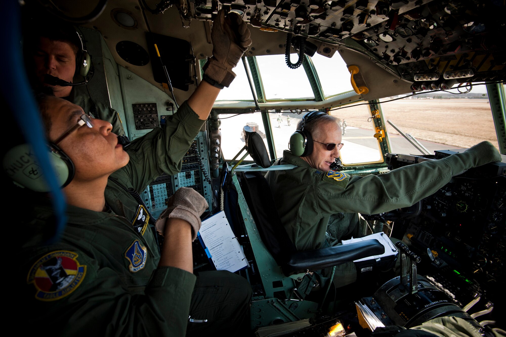YOKOTA AIR BASE, Japan -- Col. Otto Feather, 374th Airlift Wing commander, and his flight crew prepare for takeoff in a C-130H Hercules at Yokota Air Base, Japan, March 26, 2011. Colonel Feather flew five pallets of potable water to Sendai Airport to be distributed to Japanese citizens in need. (U.S. Air Force photo/Staff Sgt. Samuel Morse)