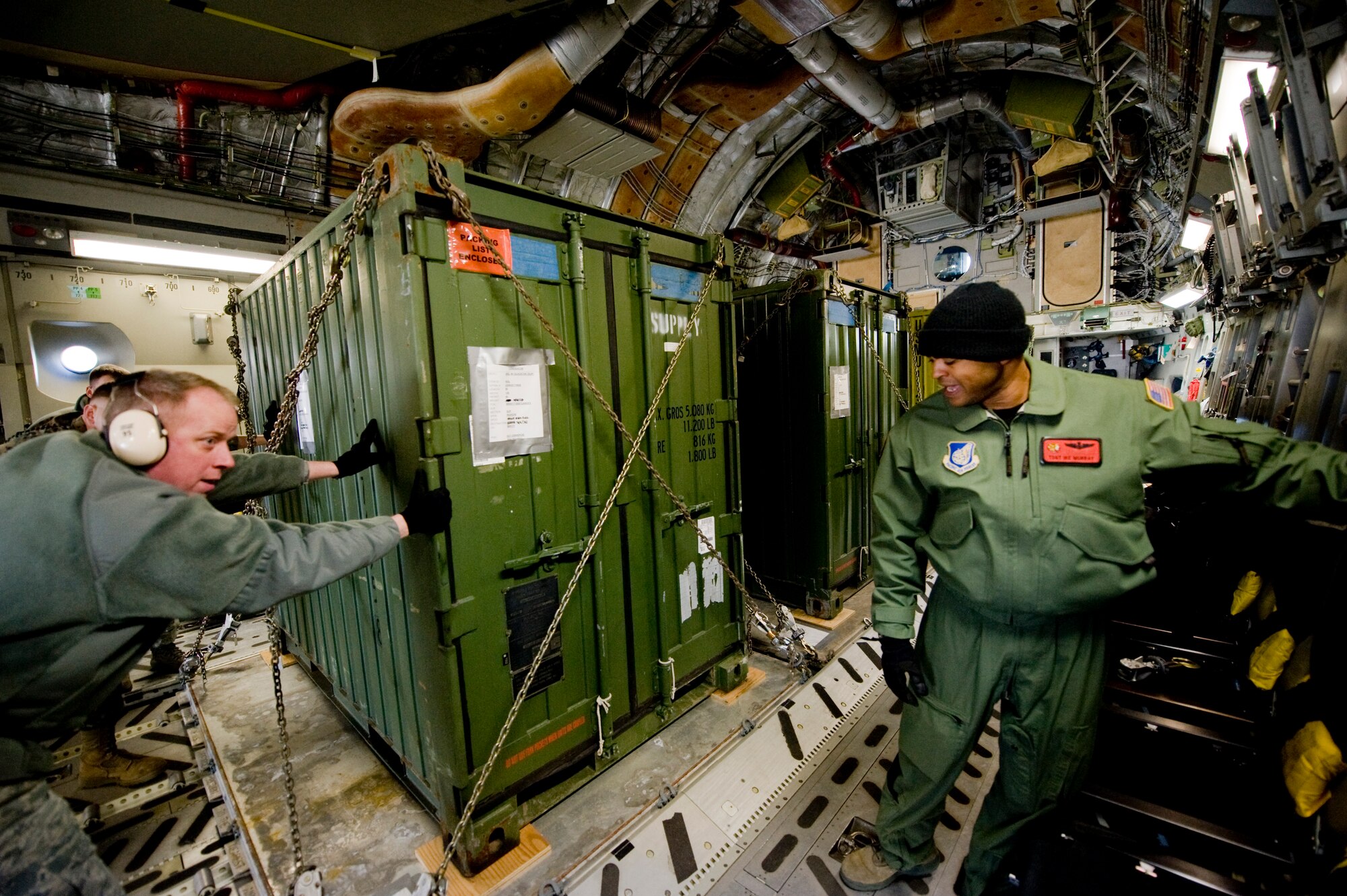 MARINE CORPS AIR STATION IWAKUNI, Japan -- Tech. Sgt. Ike Murray, 535th Airlift Squadron, locks a pallet into place on board a C-17 Globemaster III March 25, 2011. The C-17 crew flew into Marine Corps Air Station Iwakuni to pick up Marines from Marine Wing Support Squadron 171 and drop them off at Sendai Airport. The Marines travelled to Sendai Airport to setup portable showers for Japanese citizens as part of the humanitarian assistance provided during Operation Tomodachi. (U.S. Air Force photo/Staff Sgt. Jonathan Steffen) 