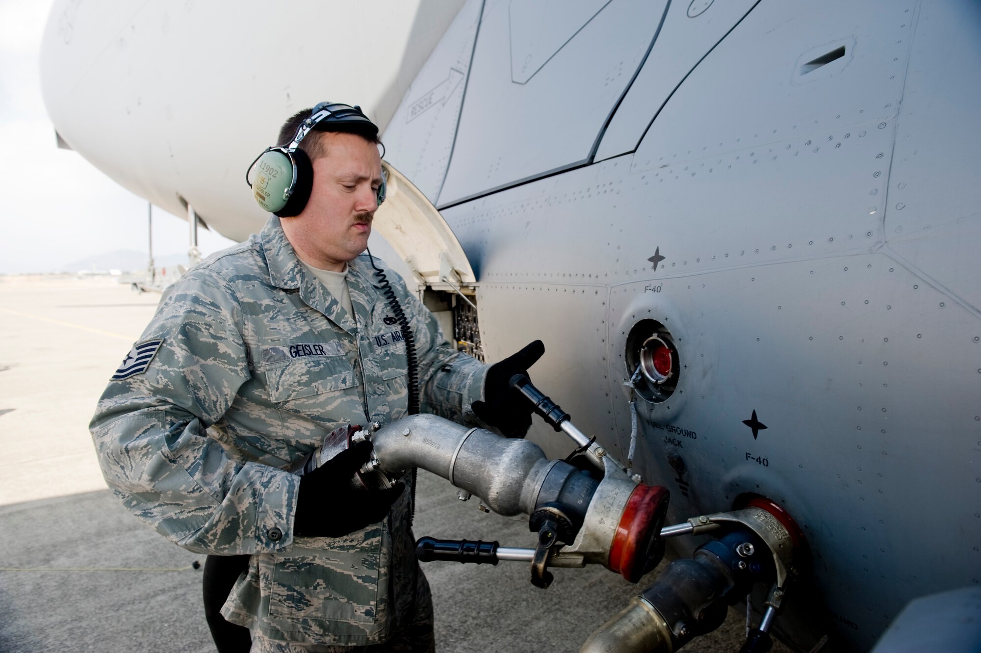 MARINE CORPS AIR STATION IWAKUNI, Japan -- Tech Sgt. Chris Geisler, 176th Aircraft Maintenance Squadron, removes a fuel nozzle from C-17 Globemaster III March 25, 2011. The C-17 crew flew into the air station to pick up Marines from Marine Wing Support Squadron 171 and drop them off at Sendai Airport. The Marines travelled to Sendai Airport to setup portable showers for Japanese citizens as part of the humanitarian assistance provided during Operation Tomodachi. (U.S. Air Force photo/Staff Sgt. Jonathan Steffen)