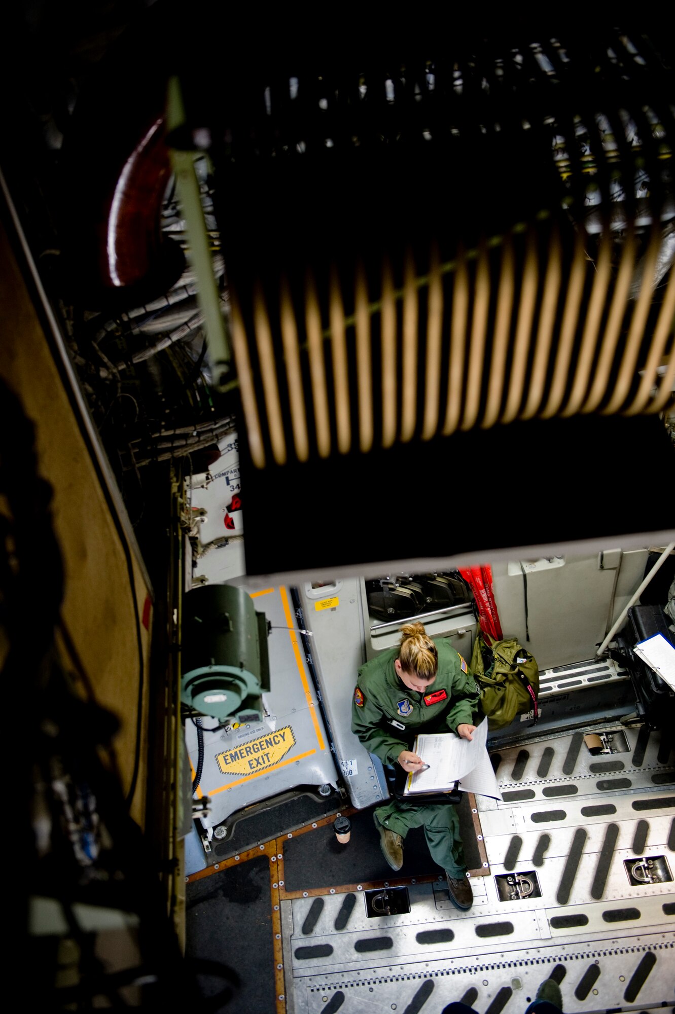 YOKOTA AIR BASE, Japan -- Senior Airman Kristina Cyphert, 535th Airlift Squadron, fills out preflight forms on board a C-17 Globemaster III March 25, 2011. The C-17 crew flew into Marine Corps Air Station Iwakuni to pick up Marines from Marine Wing Support Squadron 171 and drop them off at Sendai Airport. The Marines travelled to Sendai Airport to setup portable showers for Japanese citizens as part of the humanitarian assistance provided during Operation Tomodachi. (U.S. Air Force photo/Staff Sgt. Jonathan Steffen)