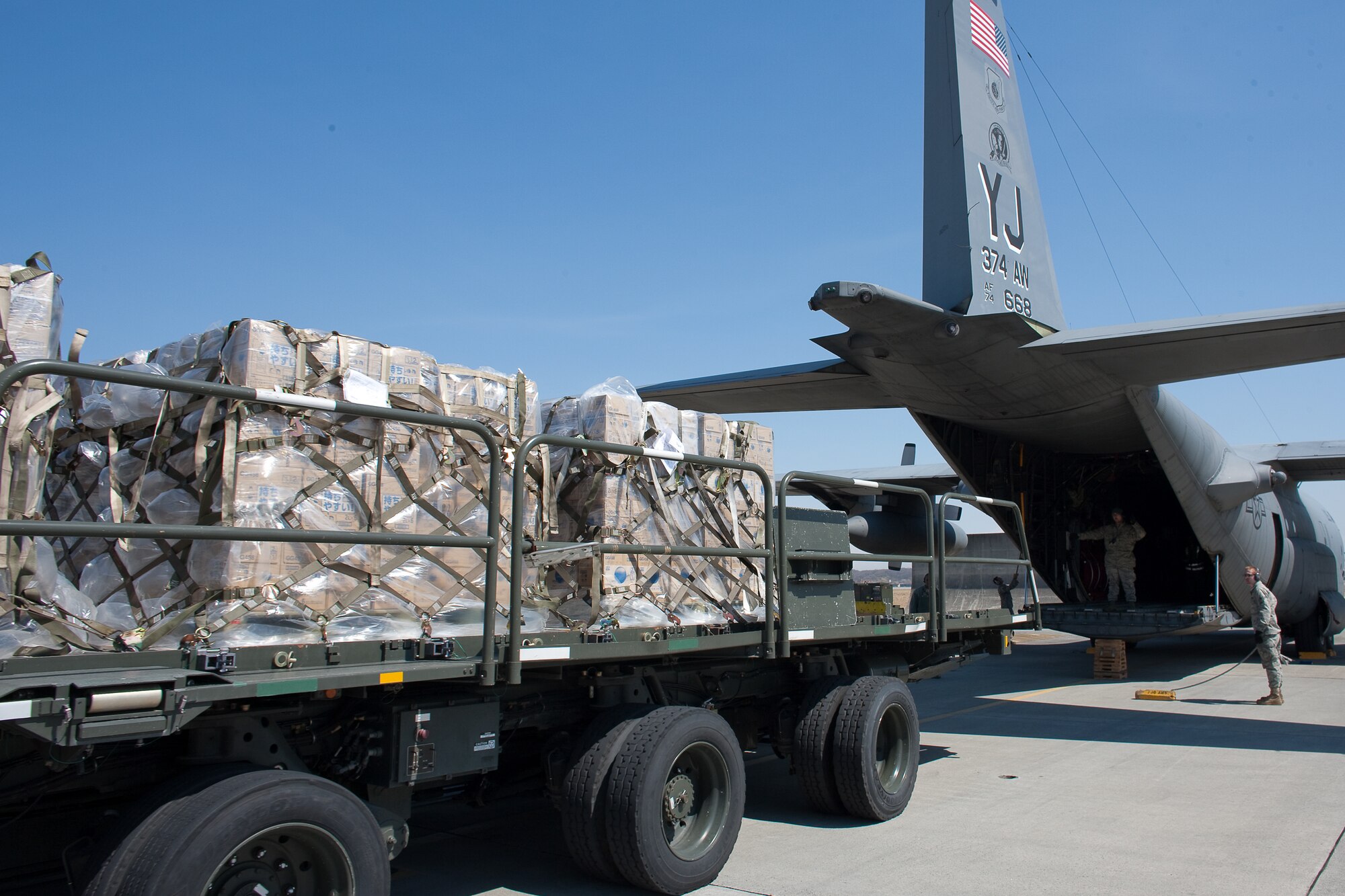 YOKOTA AIR BASE, Japan -- Members from the 730th Air Mobility Squadron load pallets of bottled water onto a C-130 Hercules at Yokota Air Base, Japan. Two C-130s from the 36th Airlift Squadron made three trips each to deliver 180,000 pounds of water to Sendai, March 26, as part of a larger mission headed up by the Government of Japan to deliver one million pounds of fresh drinking water for people in northern Japan. The water was donated by Kounoike-Unyu-Hakushu; Asahi Soft Drink Co. Ltd., Fujisan Factory; Kirin Beverage Co. Ltd, Gotenba Factory, to aid in the relief effort.