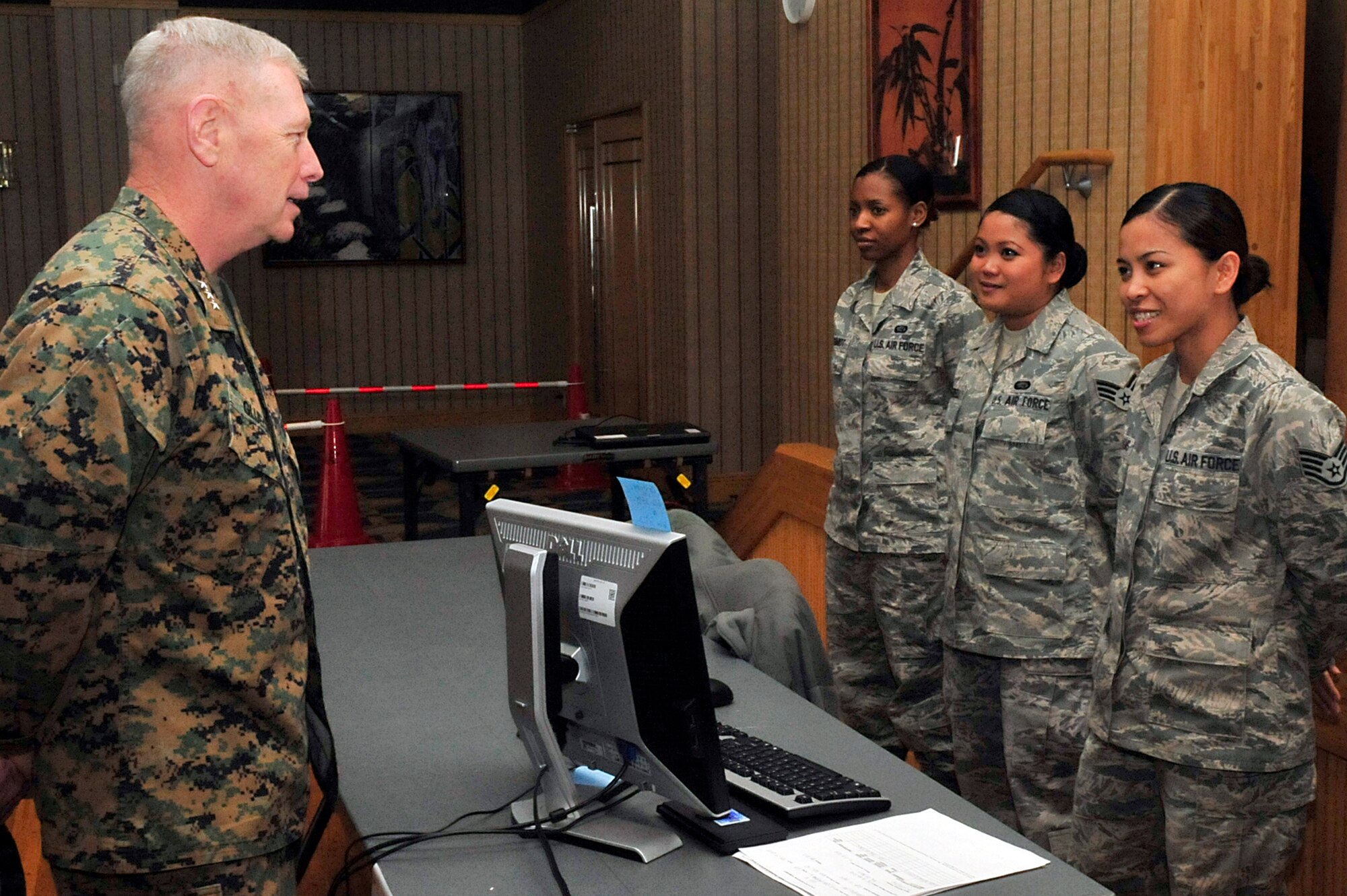 MISAWA AIR BASE, Japan -- U.S. Marine Corps Lt. Gen. Kenneth Glueck, Jr., Commanding General, III Marine Expeditionary Force, Marine Corps Base Japan, talks with Airmen about their role during the voluntary departure process Mar. 25. General Glueck came for a brief visit here to see the voluntary departure process.  (U.S. Air Force photo by Staff Sgt. Marie Brown\Released)