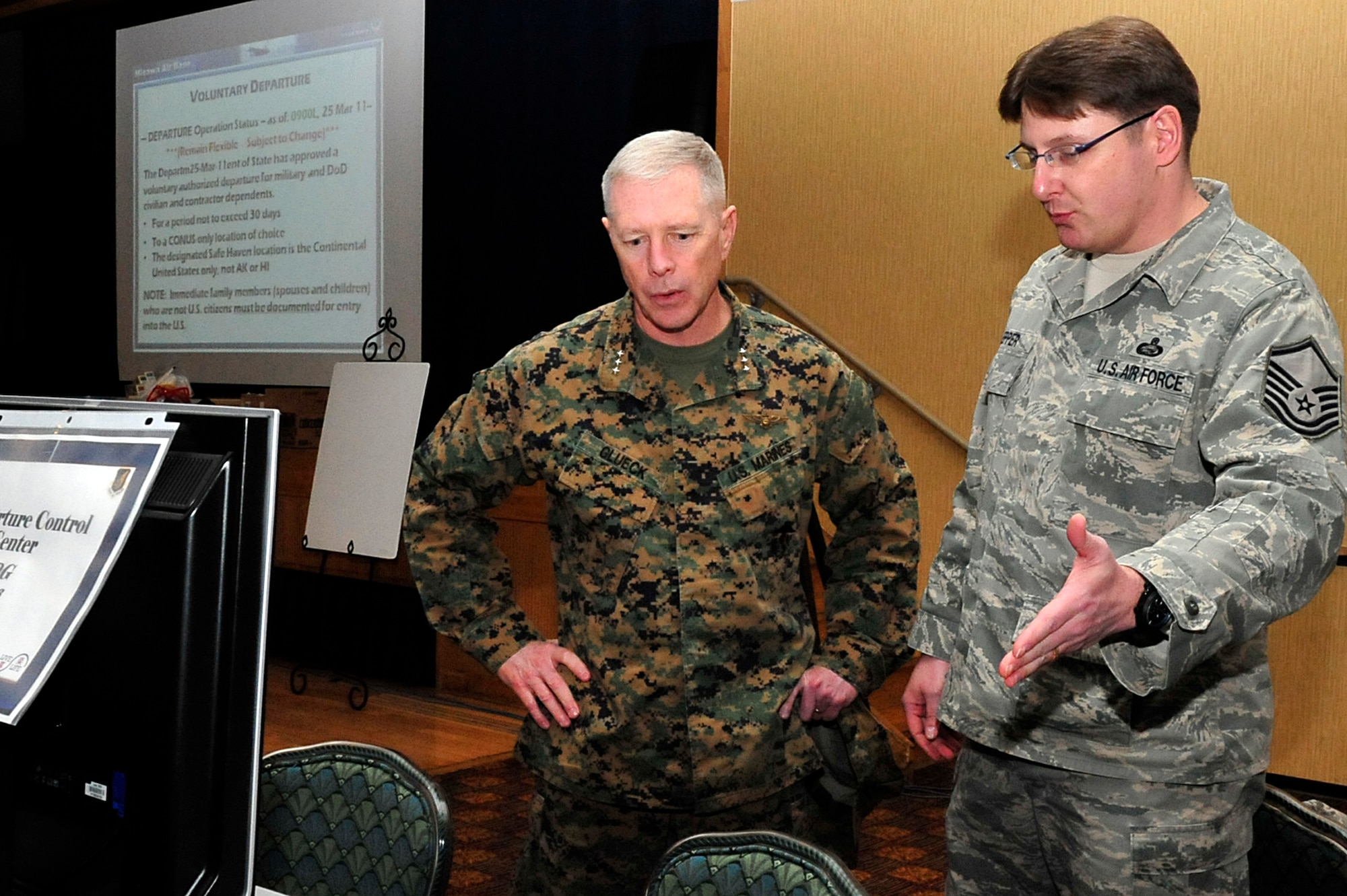 MISAWA AIR BASE, Japan -- Master Sgt. Derrick Lepper, 373rd Intelligence Surveillance and Reconnaissance Group, briefs U.S. Marine Corps Lt. Gen. Kenneth Glueck, Jr., Commanding General, III Marine Expeditionary Force, Marine Corps Base Japan, on the voluntary departure process Mar. 25. General Glueck came for a brief visit here to see the voluntary departure process.  (U.S. Air Force photo by Staff Sgt. Marie Brown\Released)
