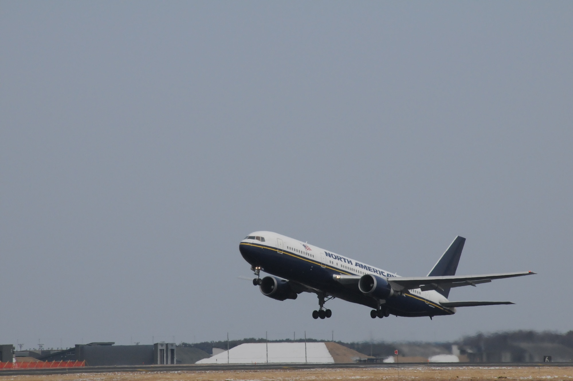 MISAWA AIR BASE, Japan -- A North American Airlines aircraft takes off from Misawa March 25. Six contracted flights departed Misawa, carrying more than 1,300 family members taking part in a voluntary departure. The voluntary departure process continues for family members who decide to leave Japan as a result of the 9.0 magnitude earthquake that struck March 11. (U.S. Air Force photo by Staff Sgt. Rachel Martinez/Released)