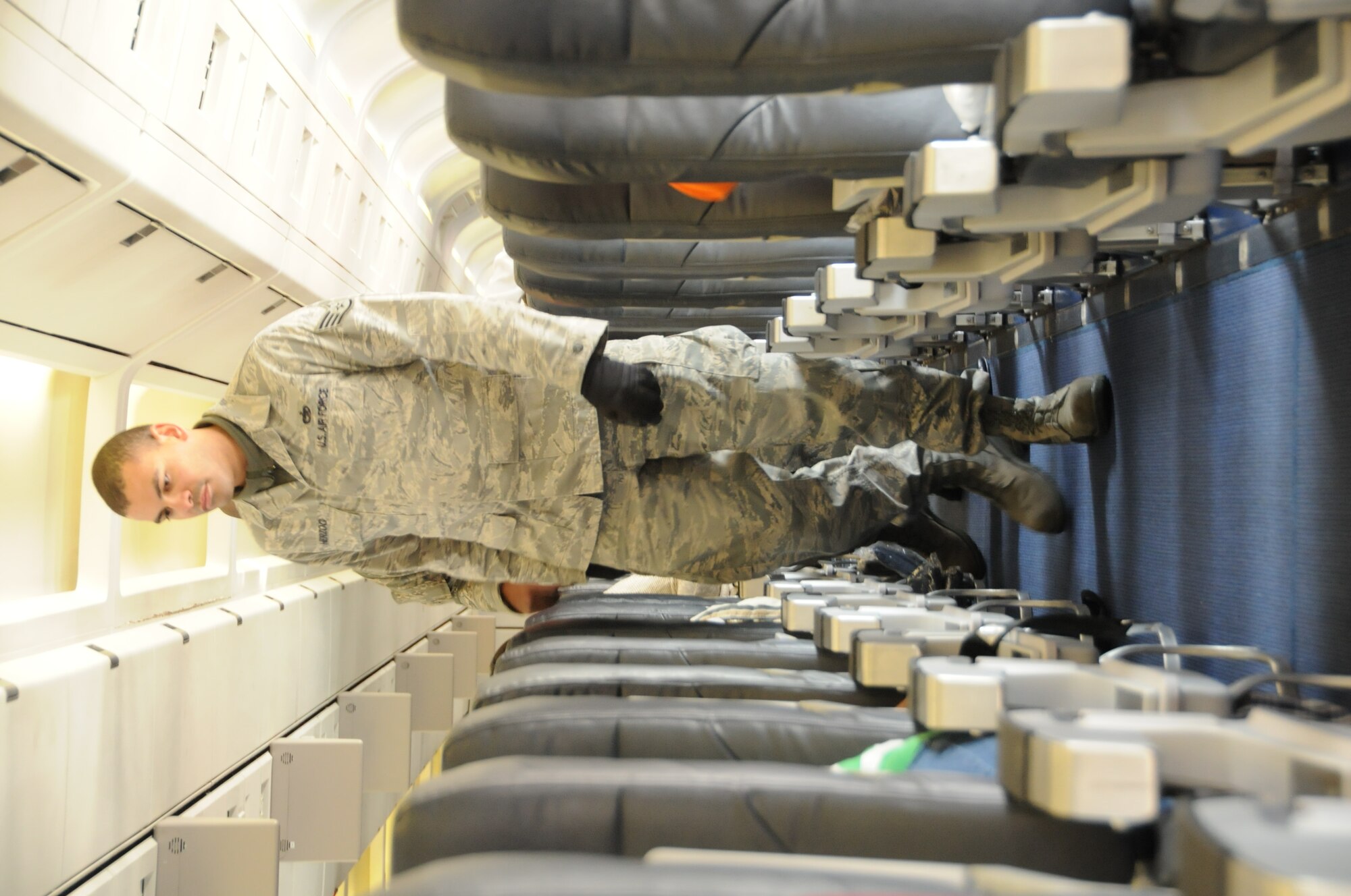 MISAWA AIR BASE, Japan -- Staff Sgt. Paul Herzog, 35th Logistics Readiness Squadron, conducts a final passenger count on a contracted flight to the U.S., March 25. Since March 22, six flights have left Misawa as part of the voluntary departure of Department of Defense family members. (U.S. Air Force photo by Staff Sgt. Rachel Martinez/Released)