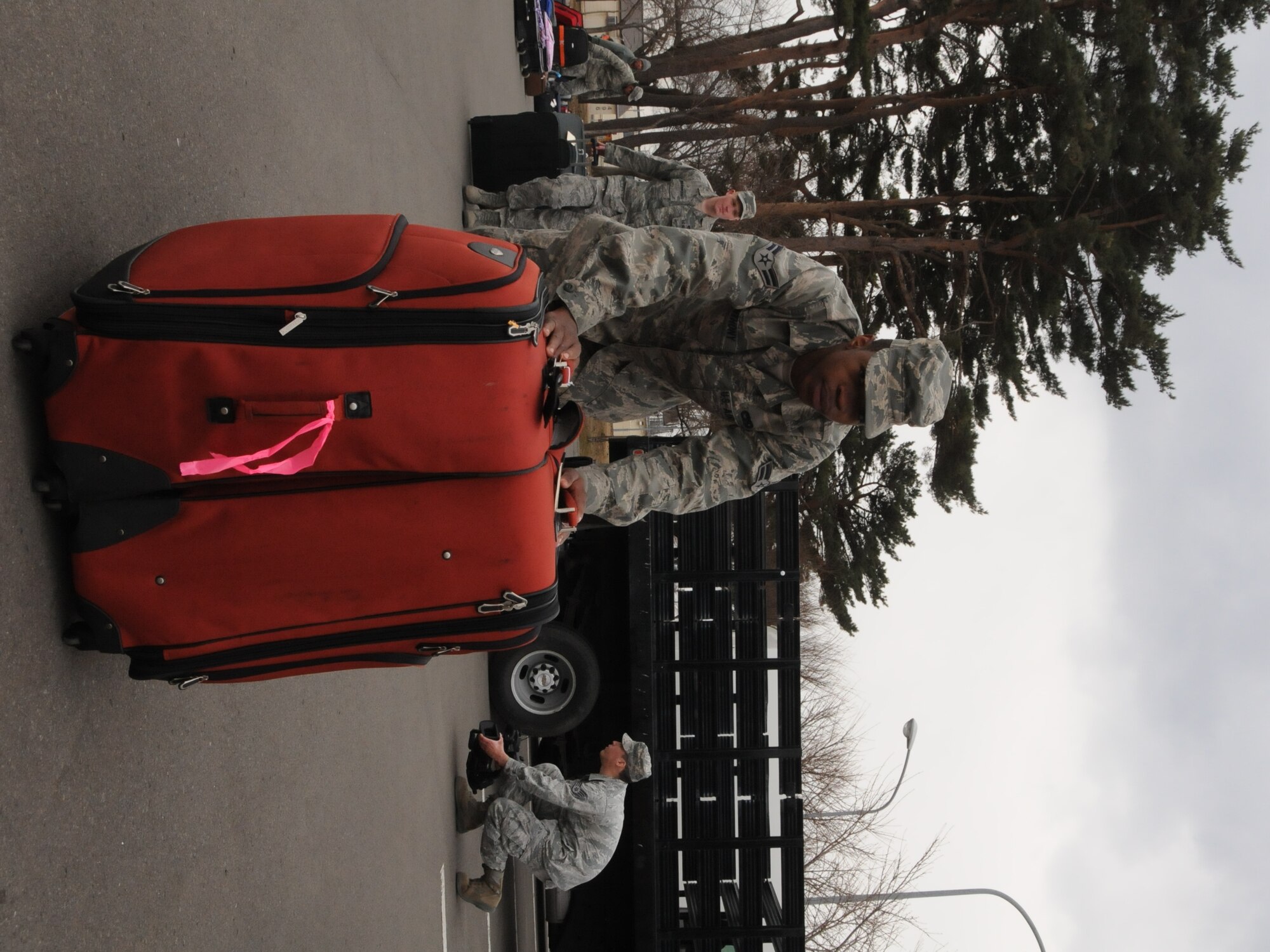 MISAWA AIR BASE, Japan -- Airman 1st Class Rodrelle Anthony, 35th Logistics Readiness Squadron, moves luggage belonging to families leaving Misawa Air Base as part of the voluntary departure March 24. Six flights have departed Misawa as part of the voluntary departure. Airman Anthony is from Selma, Ala.  (U.S. Air Force photo by Staff Sgt. Rachel Martinez/Released)