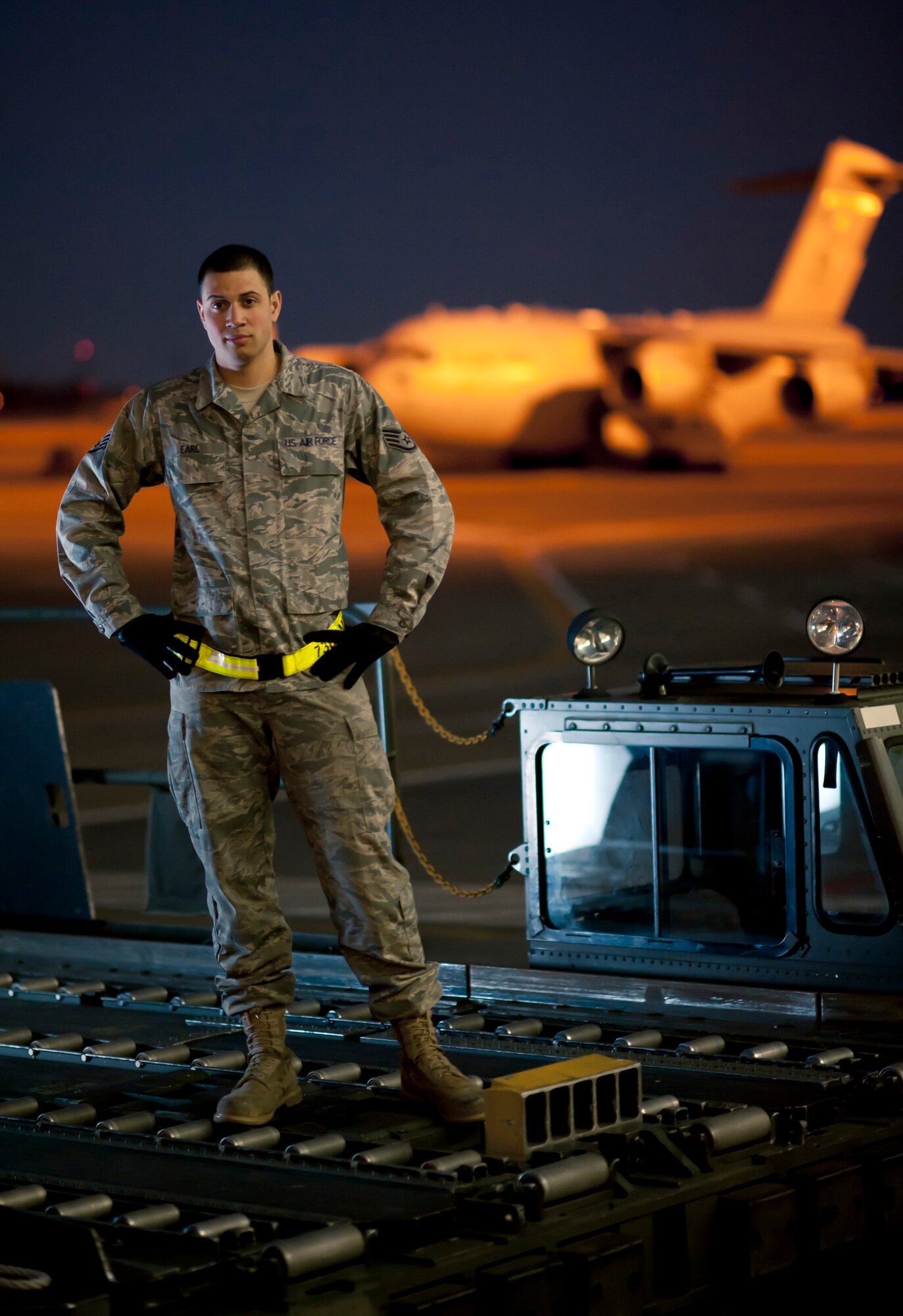 YOKOTA AIR BASE, Japan -- Staff Sgt. Mychal Earl, 730th Air Mobility Squadron ramp services supervisor, stands on a K-loader on the flightline at Yokota Air Base, Japan, March 24.  He said, "I feel proud and honored. I've been wanting to visit Japan since I was a kid. I'm finally here and get to help the Japanese people." Sergeant Earl hails from Pulaski, Tenn. (U.S. Air Force photo/Staff Sgt. Samuel Morse)