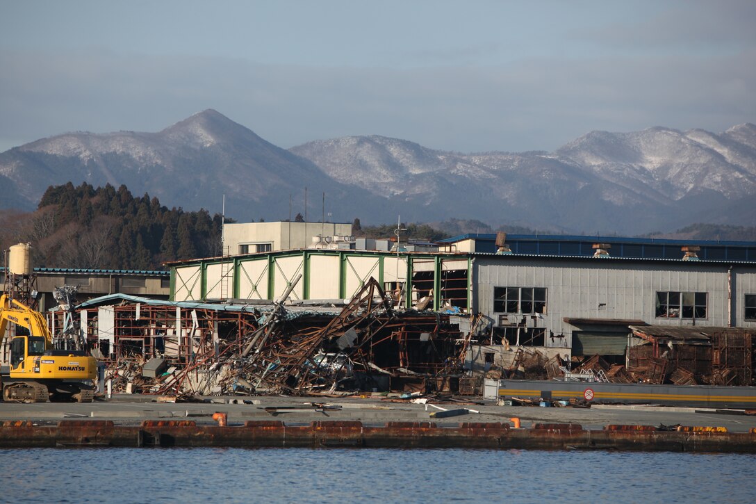 Burned buildings and debris surrounds the port here, March 27, the result of the 9.0 earthquake and tsunami.  The 31st Marine Expeditionary Unit and Amphibious Squadron 11 delivered food, water, comfort items and commercial repair vehicles to residents on the isolated island of Oshima using U.S. Navy landing craft, demonstrating the MEU’s expeditionary capabilities in ship-to-shore amphibious operations. Marines and Sailors of the 31st MEU are conducting humanitarian aid and disaster relief missions in northeast Japan in coordination with the Japanese Self Defense Forces.