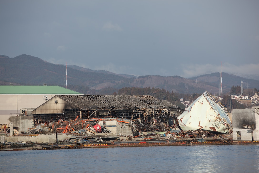 Burned buildings and debris surrounds the port here, March 27, the result of the 9.0 earthquake and tsunami.  The 31st Marine Expeditionary Unit and Amphibious Squadron 11 delivered food, water, comfort items and commercial repair vehicles to residents on the isolated island of Oshima using U.S. Navy landing craft, demonstrating the MEU’s expeditionary capabilities in ship-to-shore amphibious operations. Marines and Sailors of the 31st MEU are conducting humanitarian aid and disaster relief missions in northeast Japan in coordination with the Japanese Self Defense Forces.