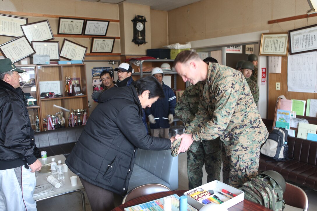 Yugi Shirahata, disaster manager on Oeshima Island (left) meets Lt. Col. William Arick, commanding officer, Combat Logistics Battalion 31, 31st Marine Expeditionary Unit here, March 27.  The 31st MEU and Amphibous Squadron 11 picked up Japanese utility repair vehicles from the port in Kessenuma and delivered food, water, comfort items and the vehicles to residents on this isolated island.  The island of Oshima has been cut off from the mainland since the earthquake and tsunami March 11.  The operation demonstrated the MEU’s expeditionary capabilities in ship-to-shore amphibious operations. Marines and Sailors of the 31st MEU are conducting humanitarian aid and disaster relief missions in northeast Japan assisting the Japanese Self Defense Forces in their ongoing operations.