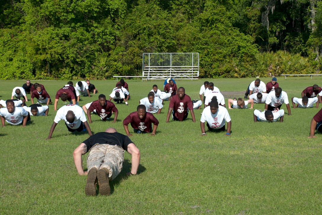Staff Sgt. Christopher H. Miller, an instructor at the Drill Instructor School, Marine Corps Recruit Depot Parris Island, S.C., leads a group of football players at a Junior Rank football camp in Jacksonville, Fla., through a session of physical training March 26.  On Jan. 3, 2012, the inaugural Semper Fidelis All-American Bowl will be held in Phoenix, Ariz.  The bowl game will feature the top 100 high school seniors that participated in the Junior Ranks football camps throughout the year.