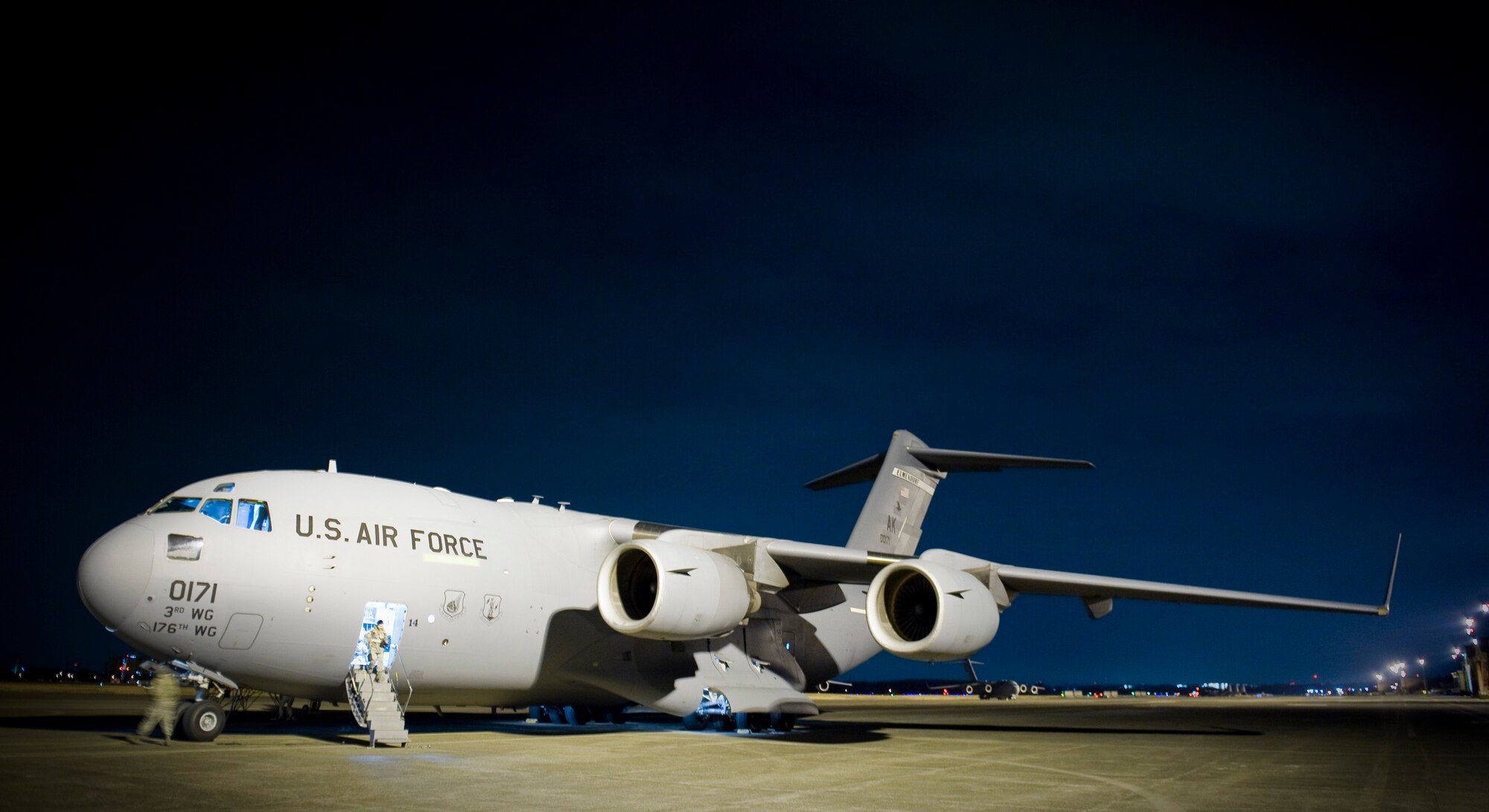 YOKOTA AIR BASE, Japan -- A C-17 Globemaster III from Elemendorf Air Force Base, Alaska sits on the flightline while receiving routing maintenance here March 28. The C-17 just returned from Sendai where supplies were dropped off in support of Operation Tomodachi. (U.S. Air Force photo/Staff Sgt. Chad C. Strohmeyer)