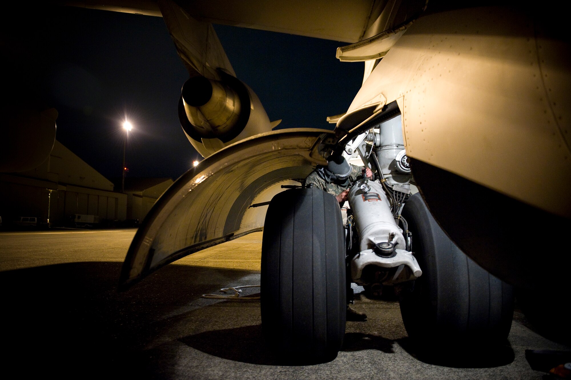YOKOTA AIR BASE, Japan -- Senior Airman Conrad Kirakosian, 730th Air Mobility Squadron crew chief, performs routine maintenance on a C-17 Globemaster III from Elemendorf Air Force Base, Alaska here March 28. The C-17 just returned from Sendai where supplies were dropped off in support of Operation Tomodachi. (U.S. Air Force photo/Staff Sgt. Chad C. Strohmeyer)