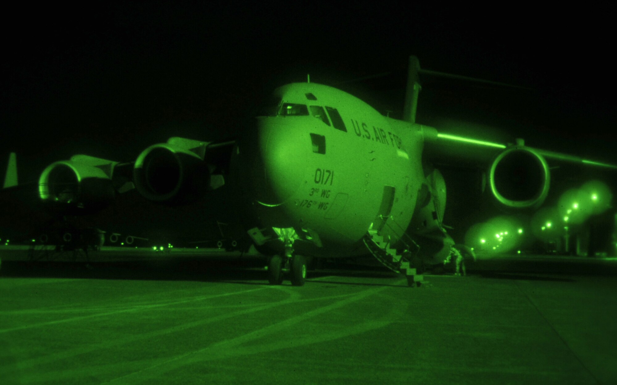 YOKOTA AIR BASE, Japan -- A C-17 Globemaster III from Elmendorf, Alaska, receives routine maintenance from 730th Air Mobility Squadron crew chiefs here March 28, 2011. The C-17 arrived after delivering relief supplies to Sendai. Since the March 11 earthquake and tsunami, Yokota members have worked around the clock delivering vital supplies in support of Operation Tomodachi. (U.S. Air Force photo/Airman 1st Class Andrea Salazar)
