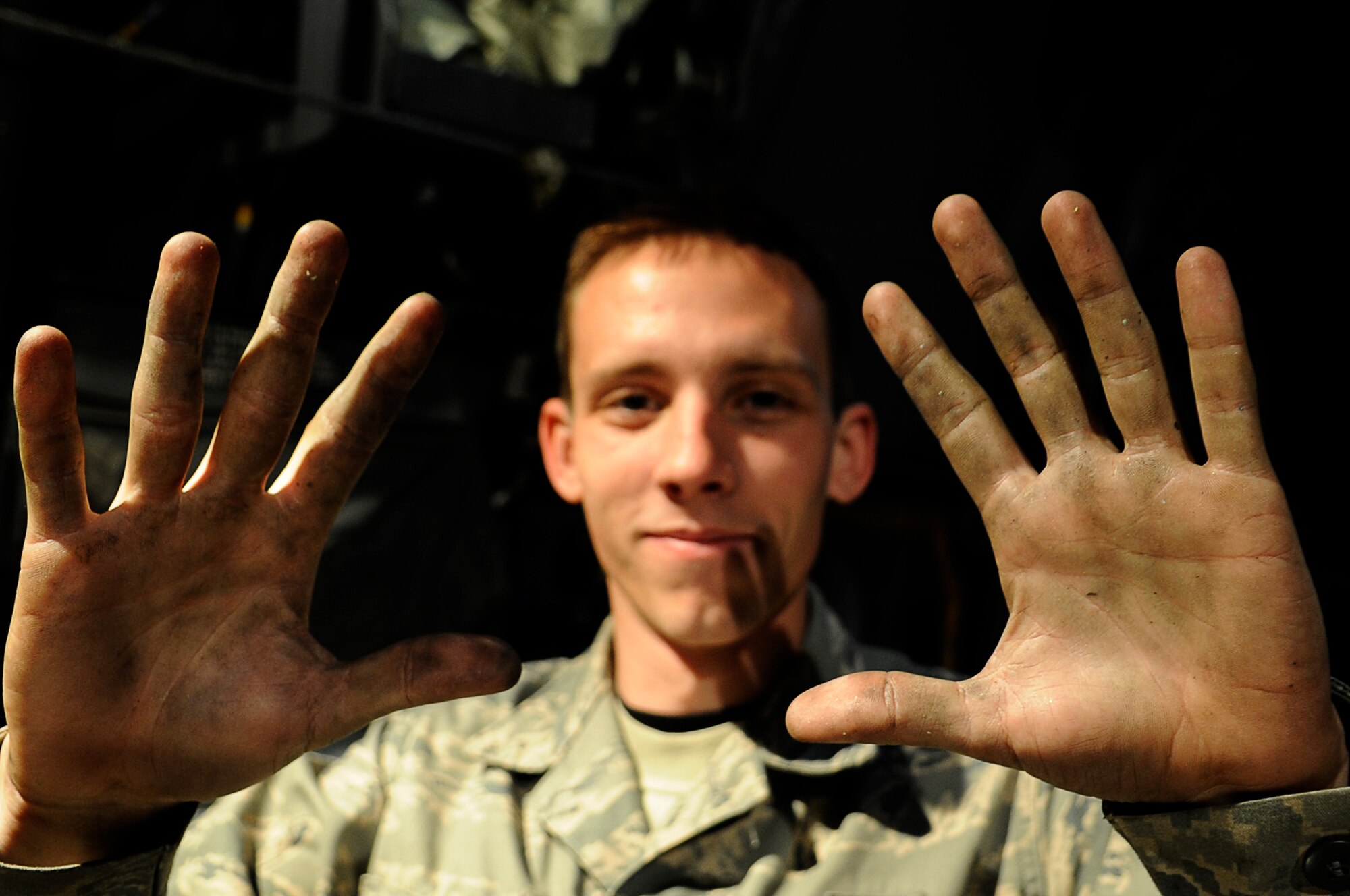 YOKOTA AIR BASE, Japan -- Airman 1st Class Dustin Lingel, 374th Aircraft Maintenance Squadron, shows that sometimes you have to get your hands dirty to get the job done at Yokota March 23. The Airmen assigned to the 374th Airlift Wing are committed to providing support during ongoing disaster relief operations. (U.S. Air Force photo/Master Sgt. Jeromy K. Cross)








