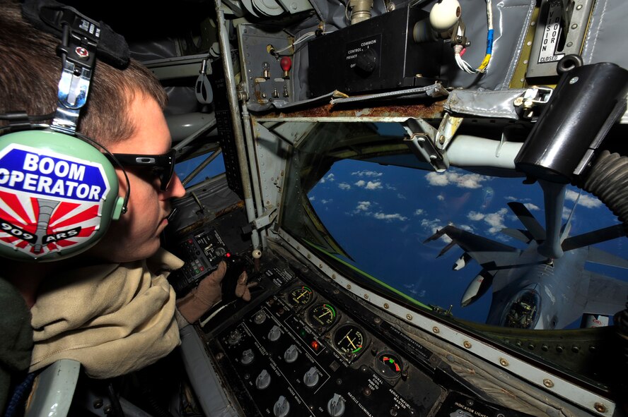 Airman 1st Class Derek Greene, an in-flight refueling technician, with the 909th Air Refueling Squadron, operates a boom aboard a KC-135 Stratotanker to deliver fuel to an F-16 Fighting Falcon from the 14th Fighter Squadron, Misawa Air Base, while flying over the Sea of Japan March 27. The KC-135 provides aerial refueling support to Air Force, Navy and Marine Corps aircraft as well as aircraft of allied nations. (U.S. Air Force photo/Staff Sgt. Lakisha A. Croley)